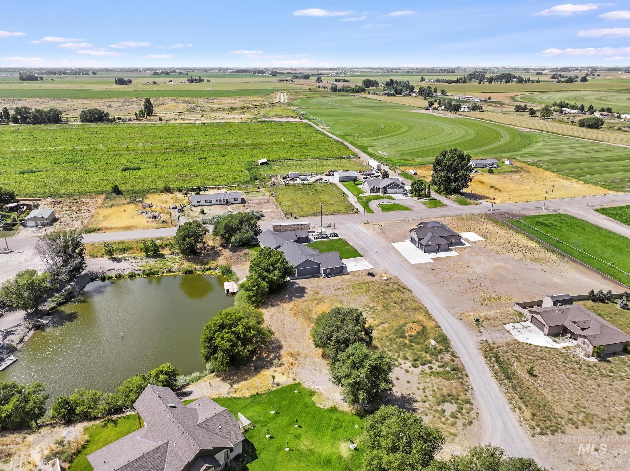 Aerial view of sparsely populated area featuring a nearby body of water