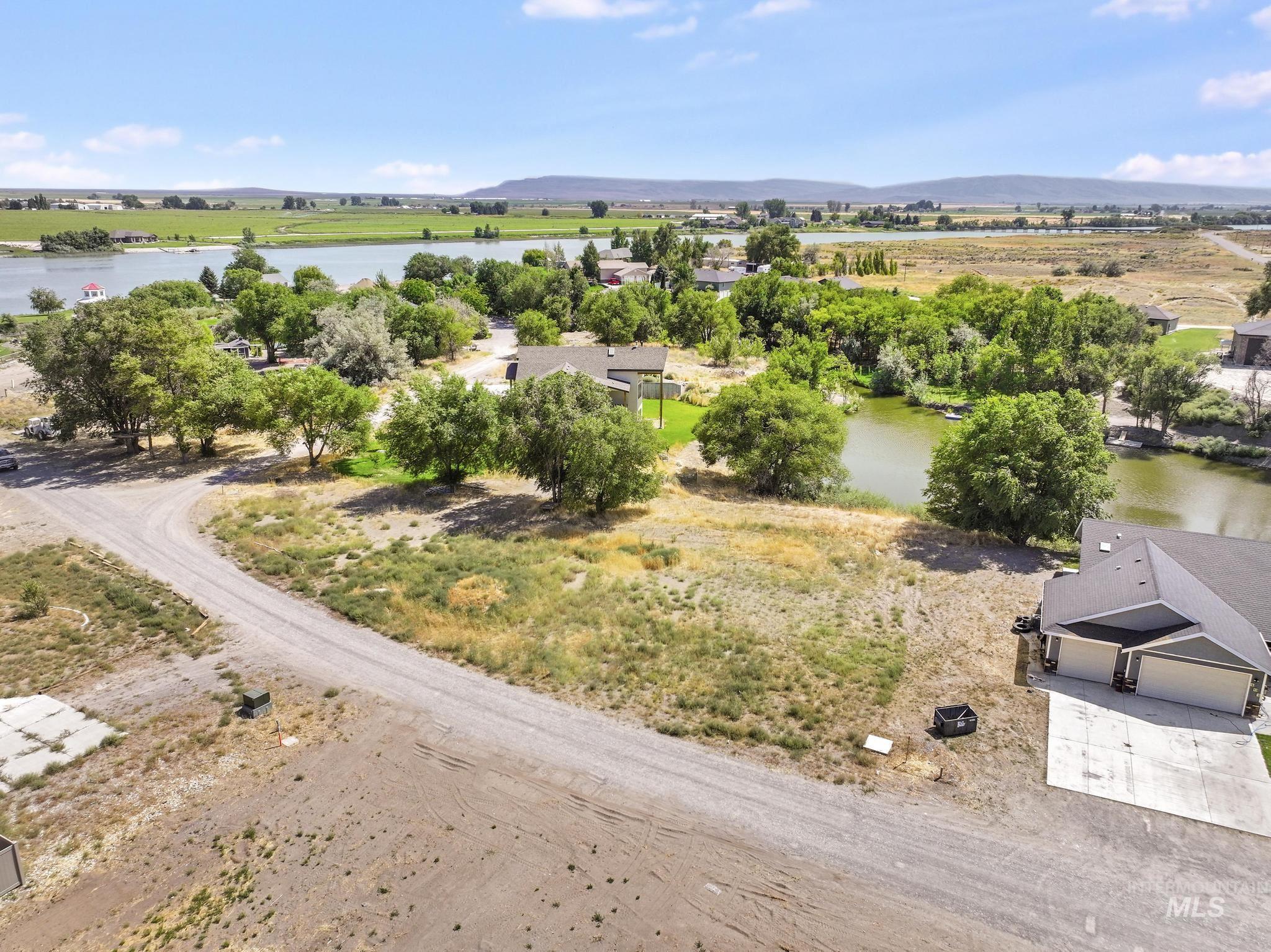 Aerial view of sparsely populated area with a water and mountain view