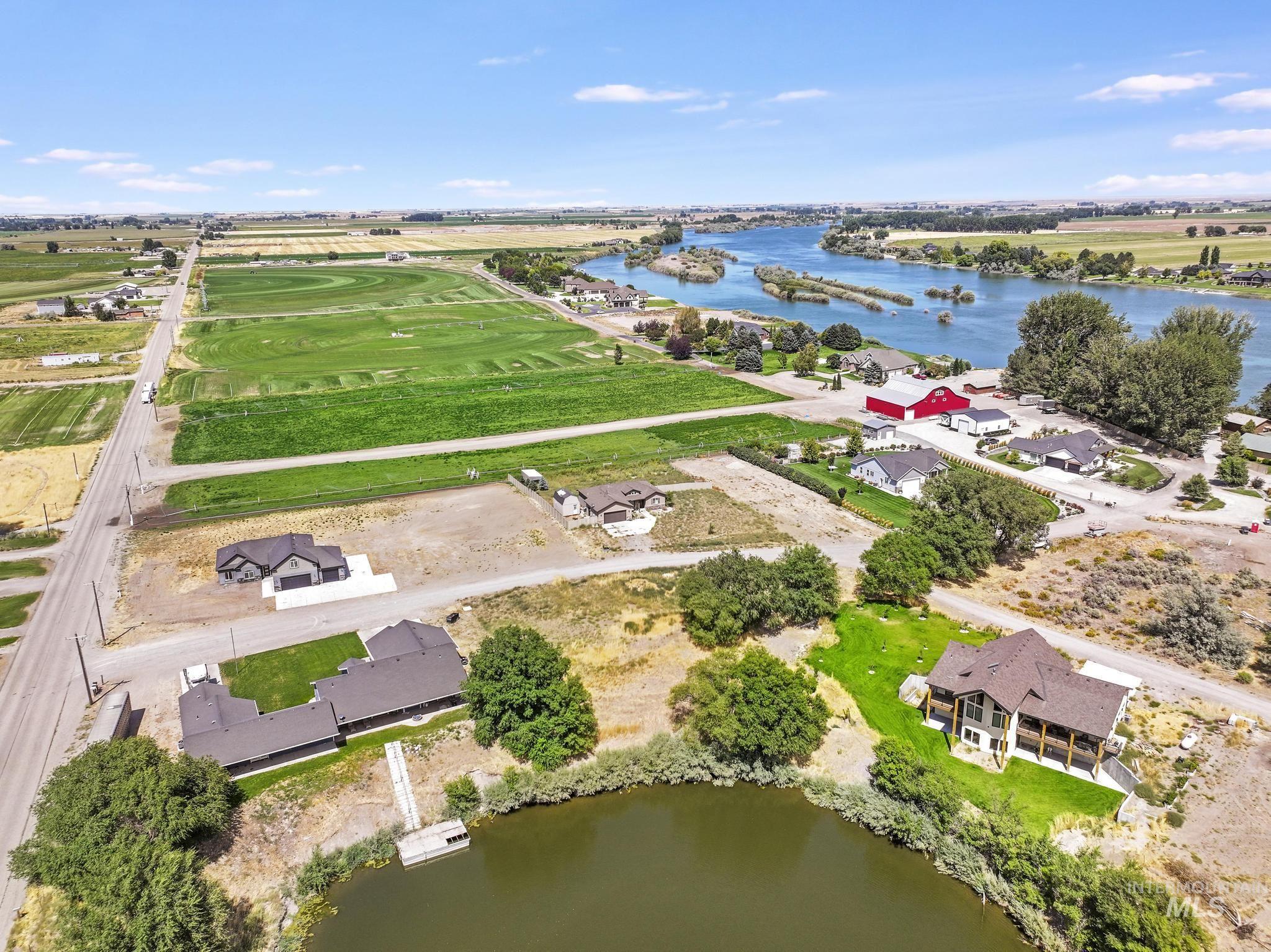 View of property location with a large body of water and nearby suburban area