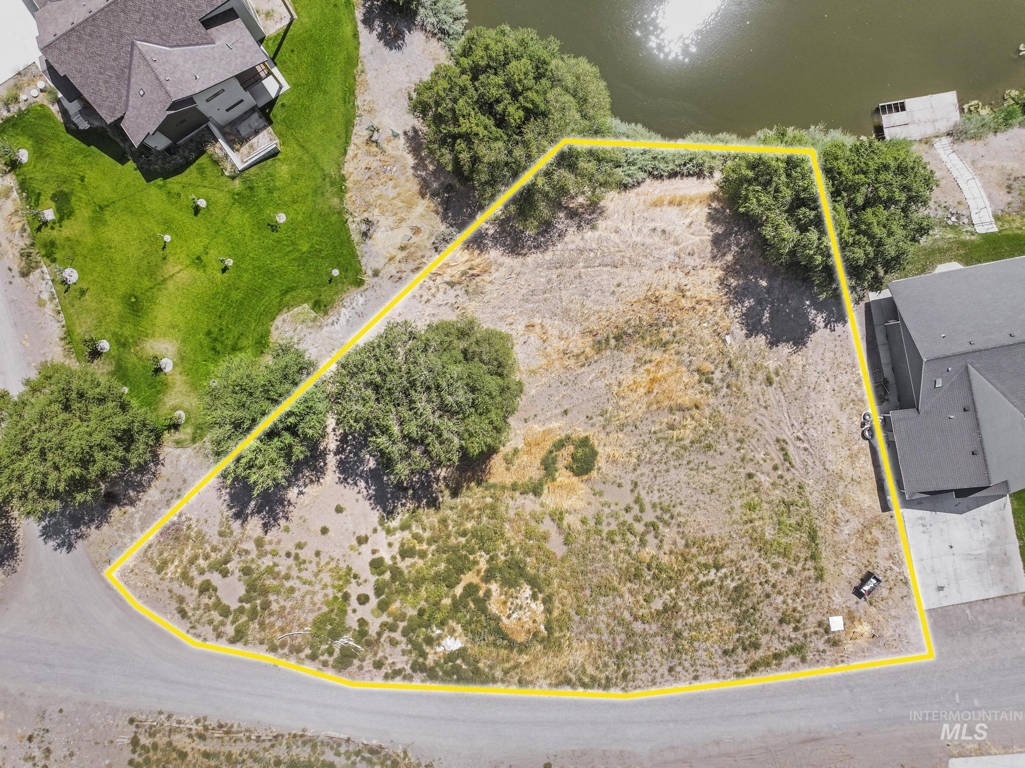 View of property location with property parcel outlined and a nearby body of water