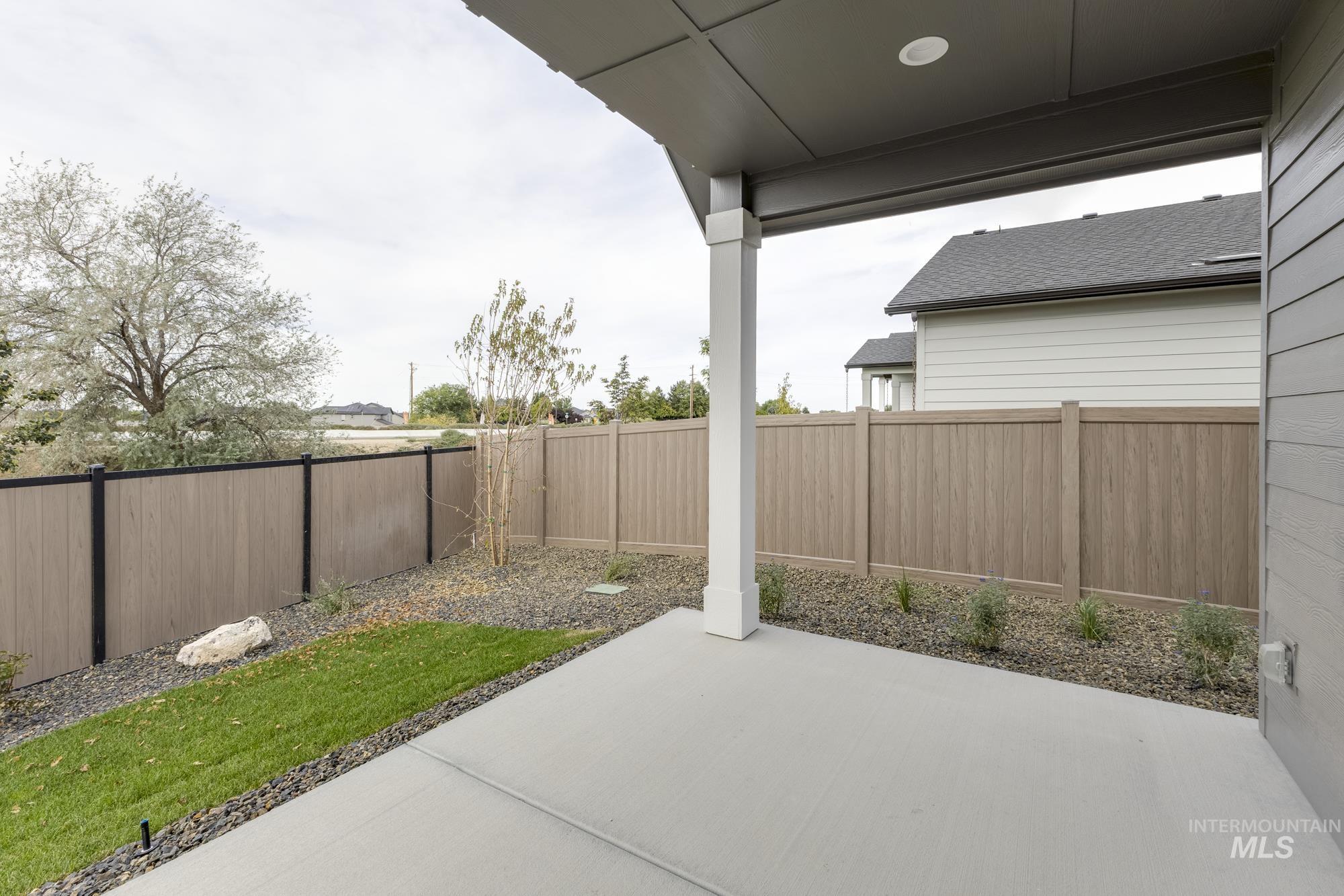 Fenced backyard with a patio