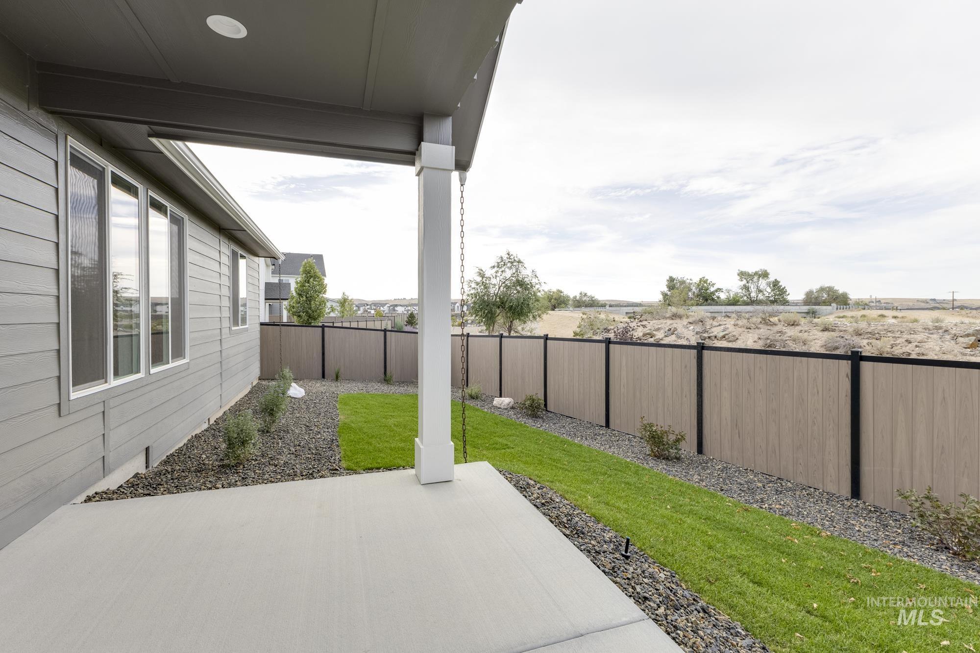 Fenced backyard with a patio area