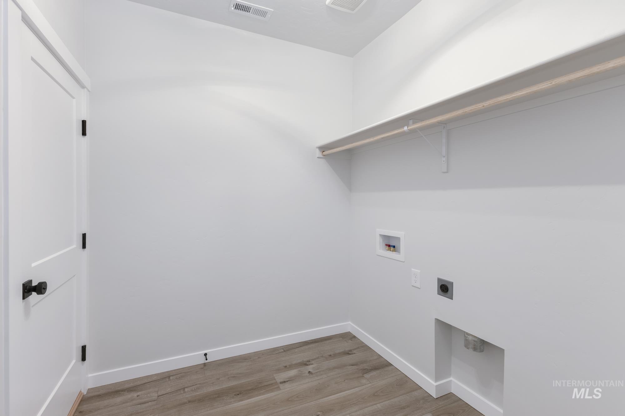 Laundry room with light wood-type flooring, electric dryer hookup, and hookup for a washing machine