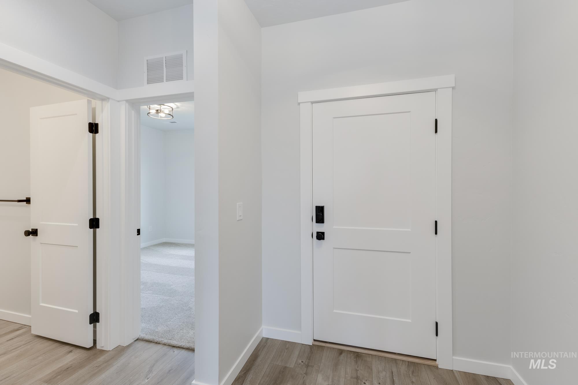 Entrance foyer with light wood-style floors