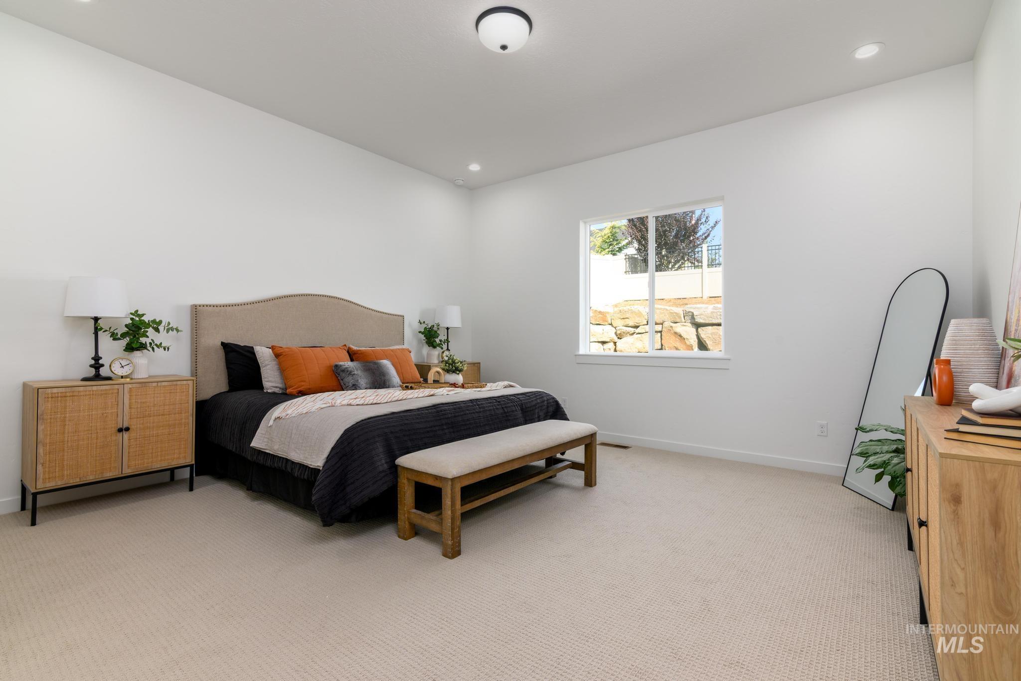 Spacious room featuring neutral carpeting, a large window, recessed lighting, and a flush mount ceiling fixture