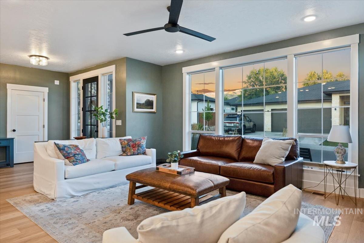 Living area with wood finished floors and ceiling fan