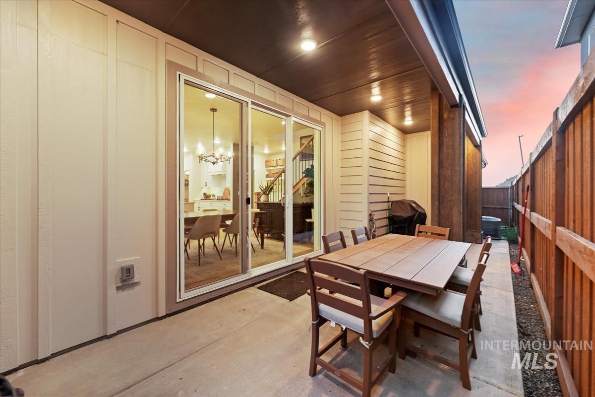 Patio terrace at dusk with a patio and outdoor dining area