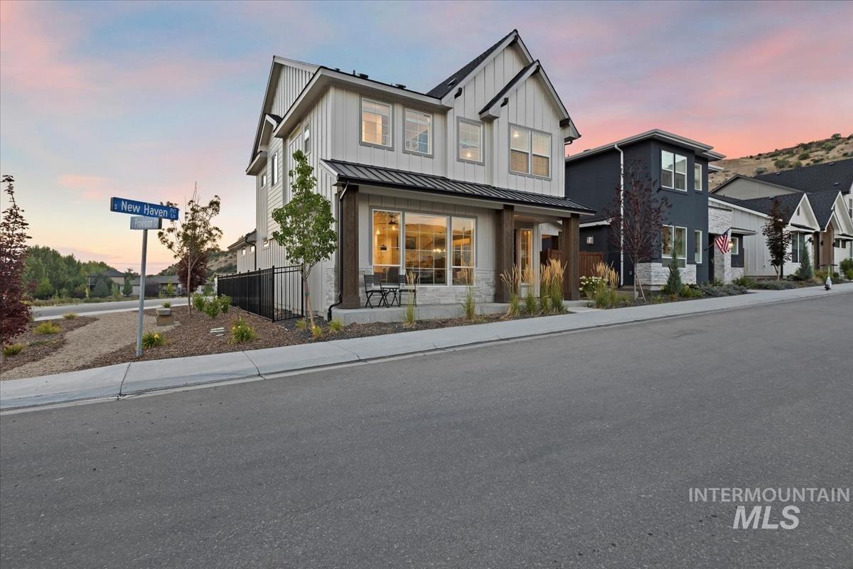 Modern farmhouse style home with a metal roof, a standing seam roof, and board and batten siding
