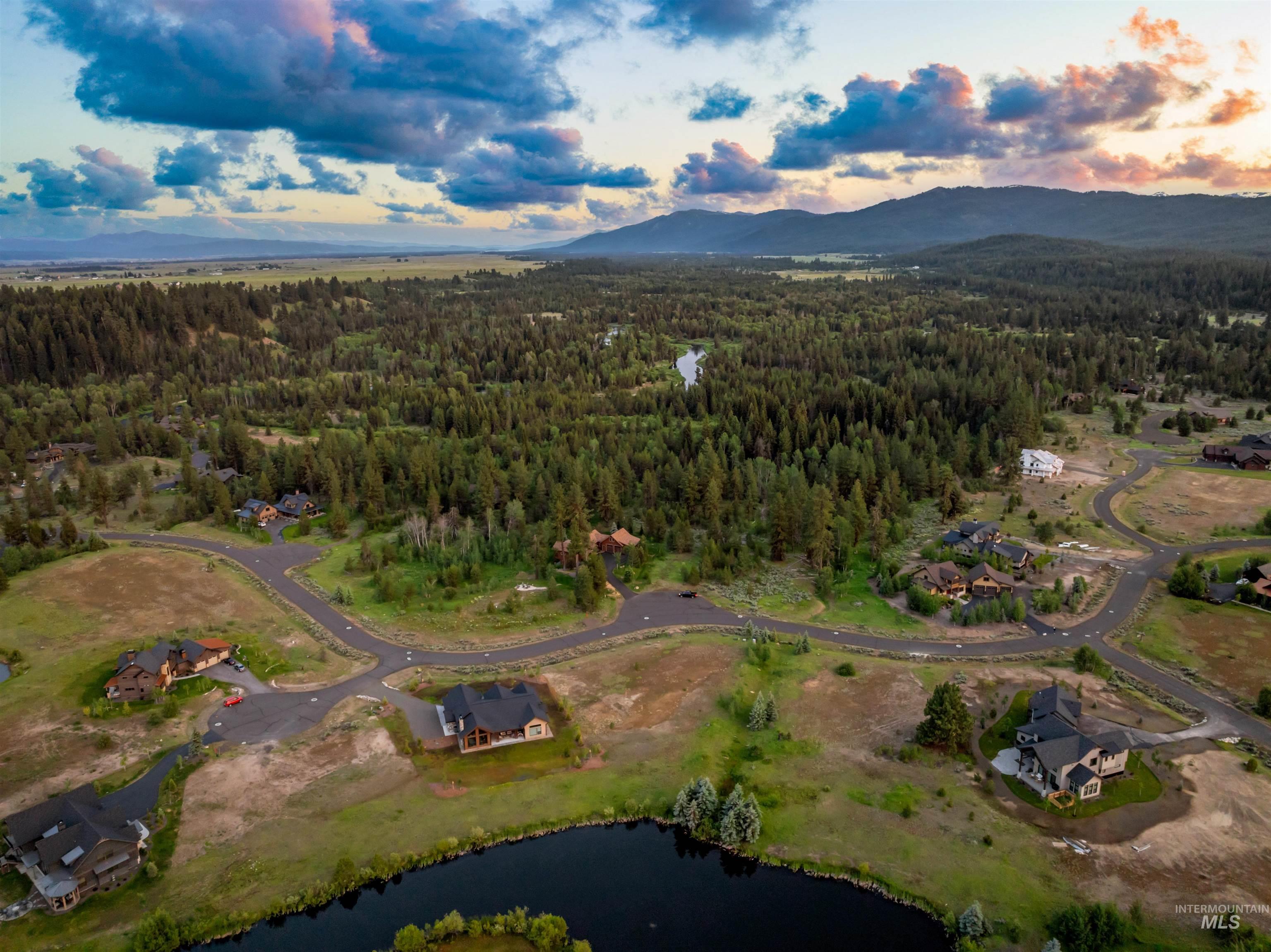 Aerial view at dusk of a wooded view and a water and mountain view
