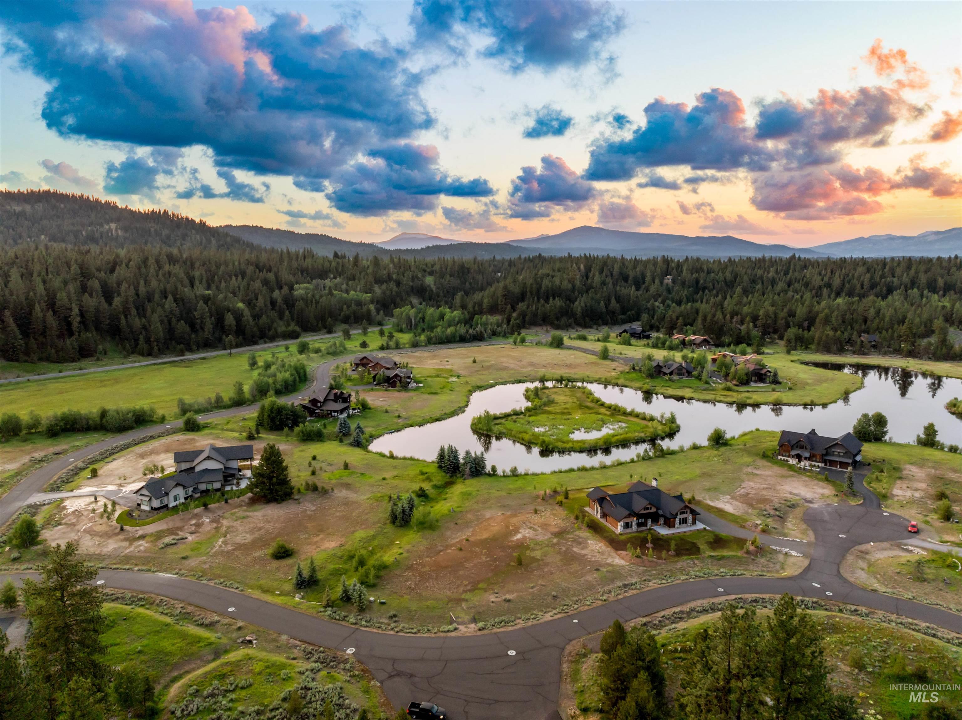 Aerial view at dusk of a wooded view and a water and mountain view
