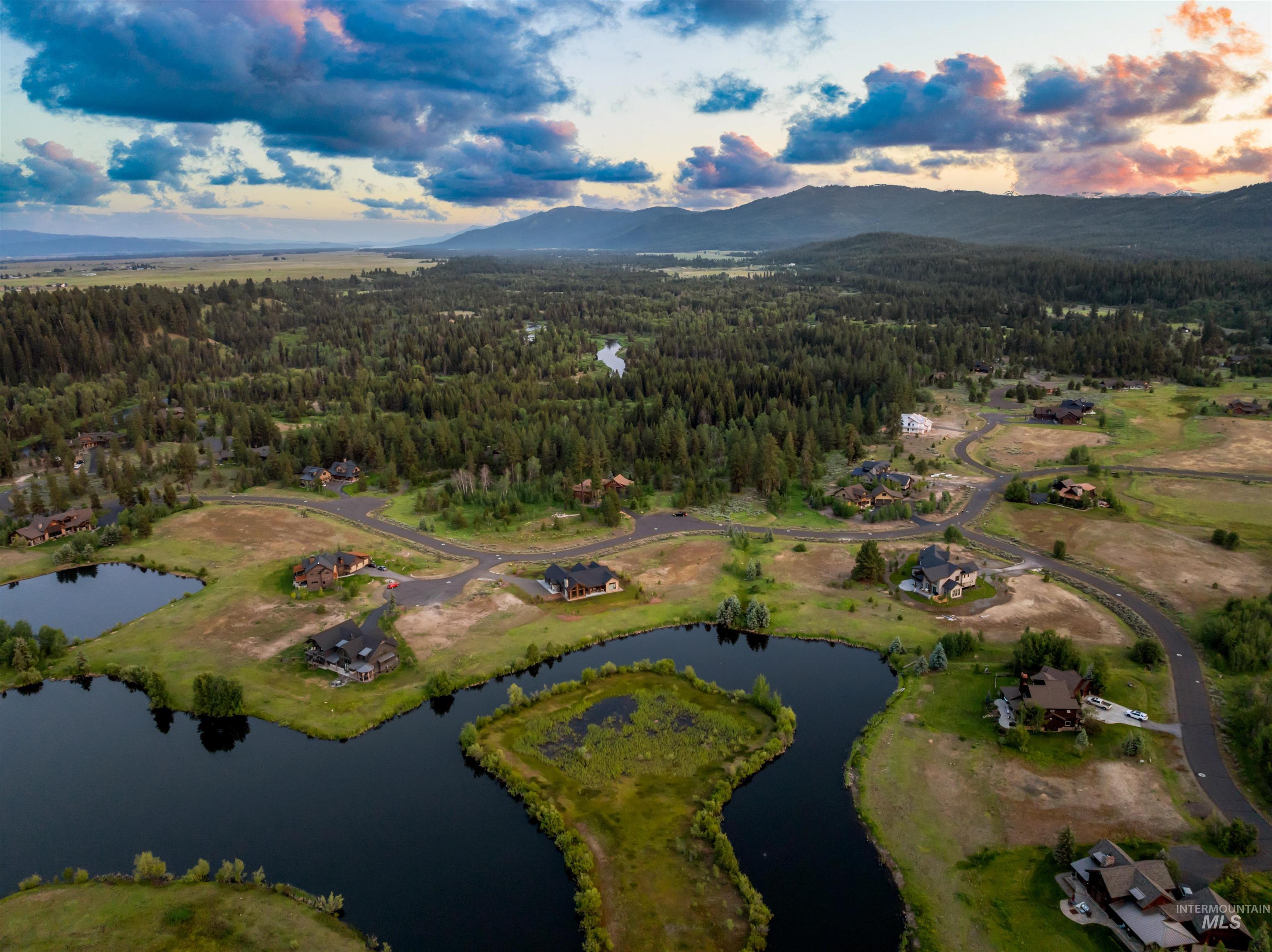Aerial view of property's location featuring a water and mountain view
