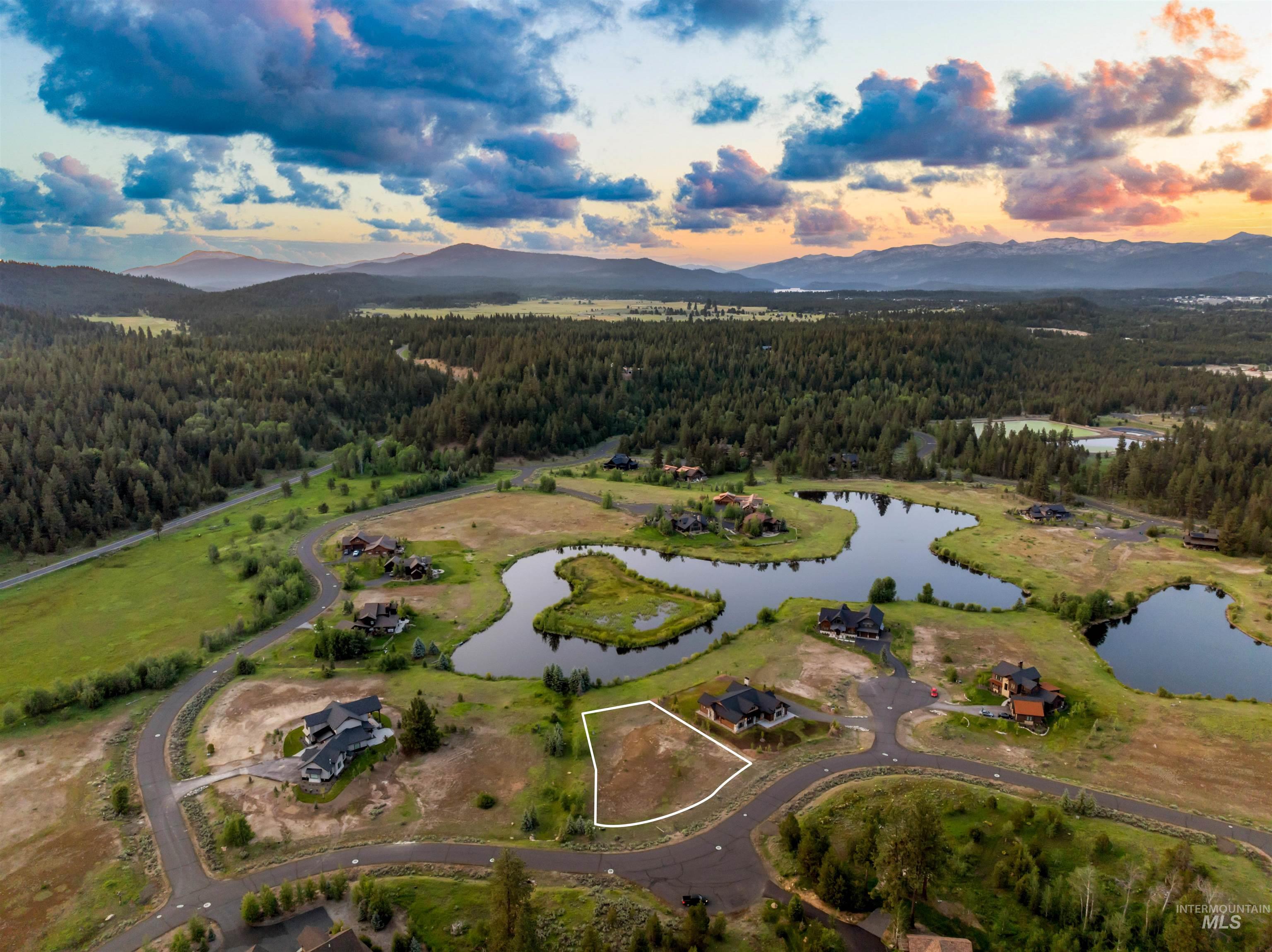 Aerial view at dusk of a view of trees and a water and mountain view