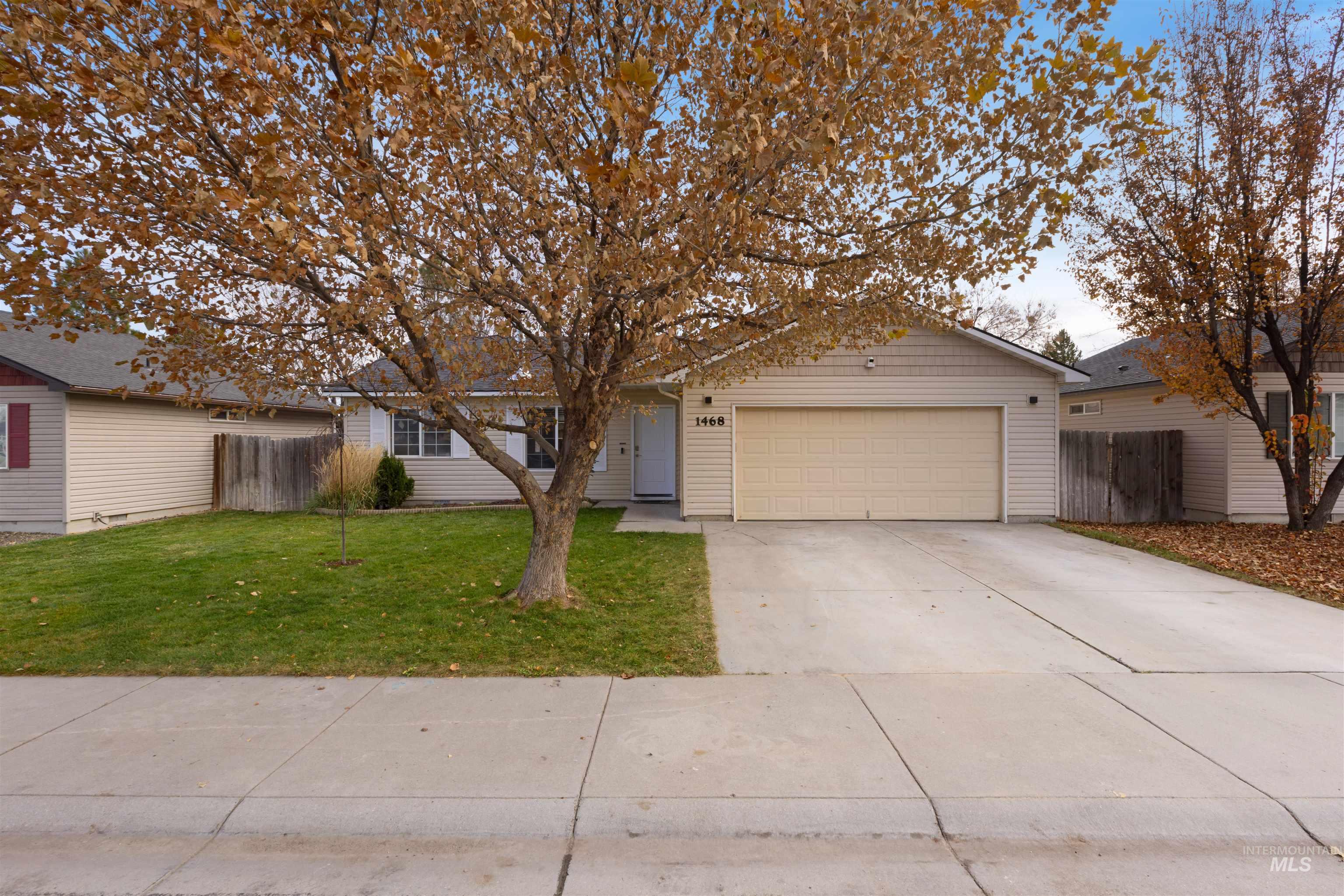 View of front of home featuring concrete driveway and an attached garage