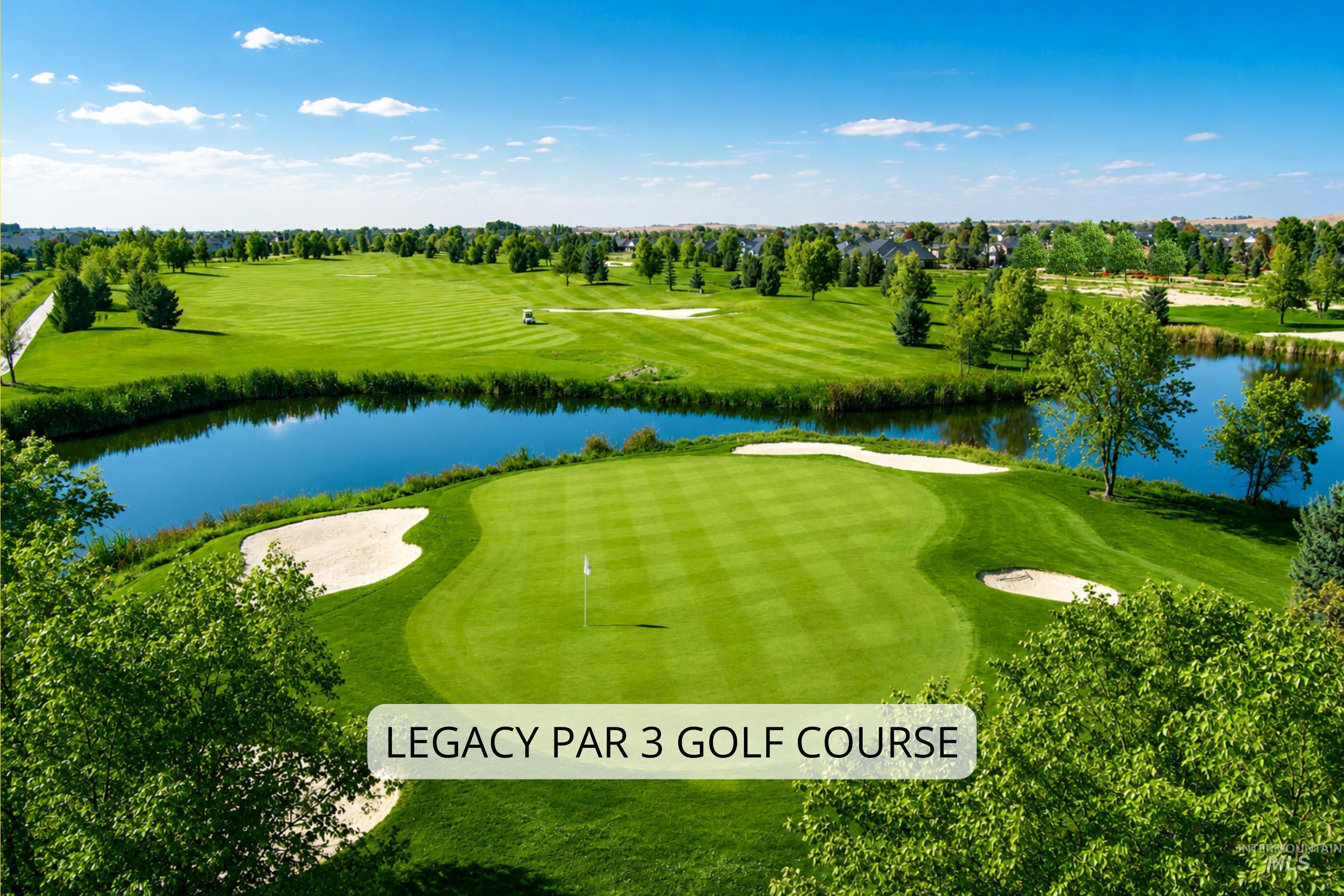Manicured golf course featuring a putting green with a flag, a sand trap, and a water feature