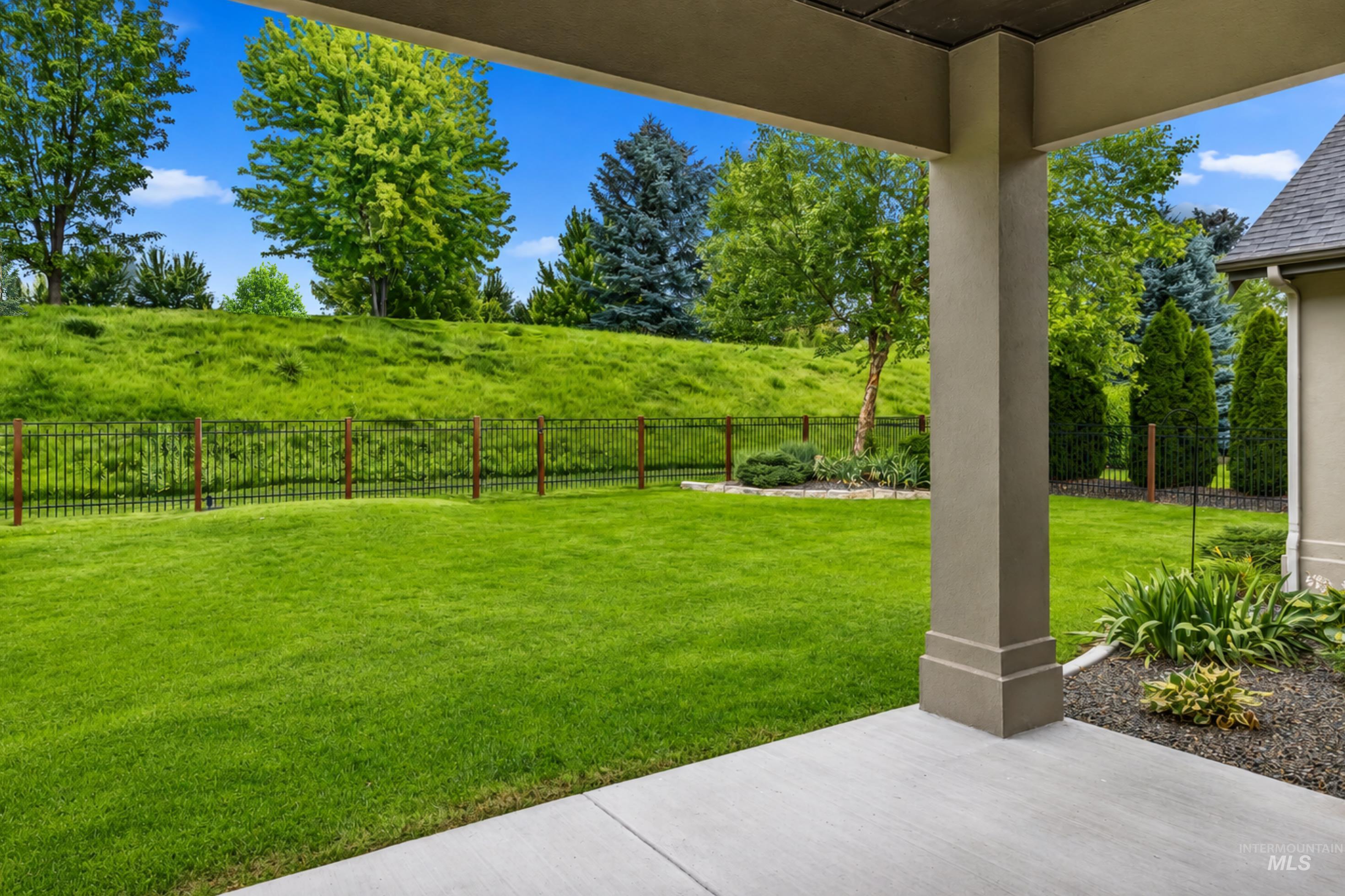 Covered patio area featuring a concrete surface and a substantial support column