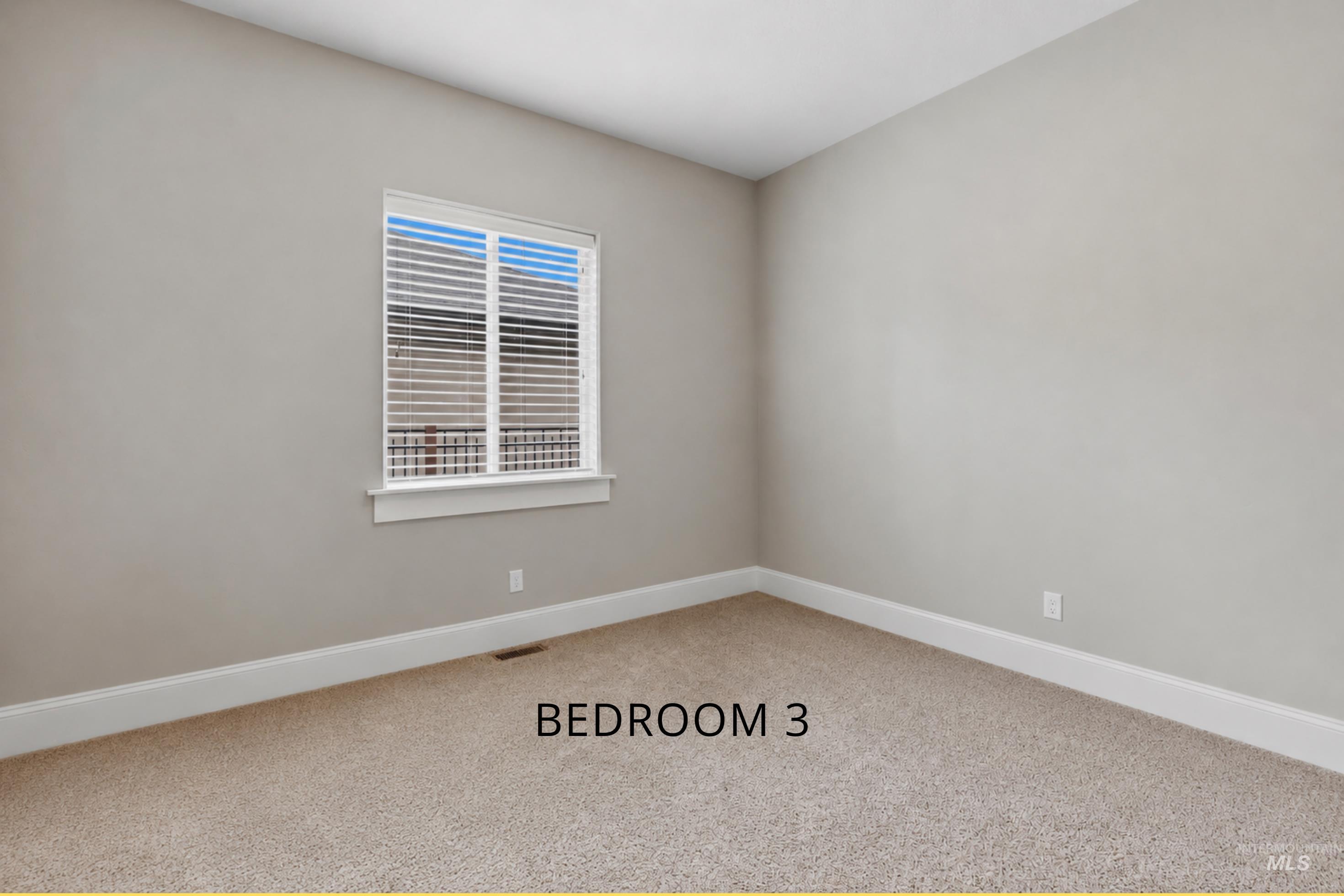 Carpeted room featuring neutral wall paint, white trim, and a window with horizontal blinds