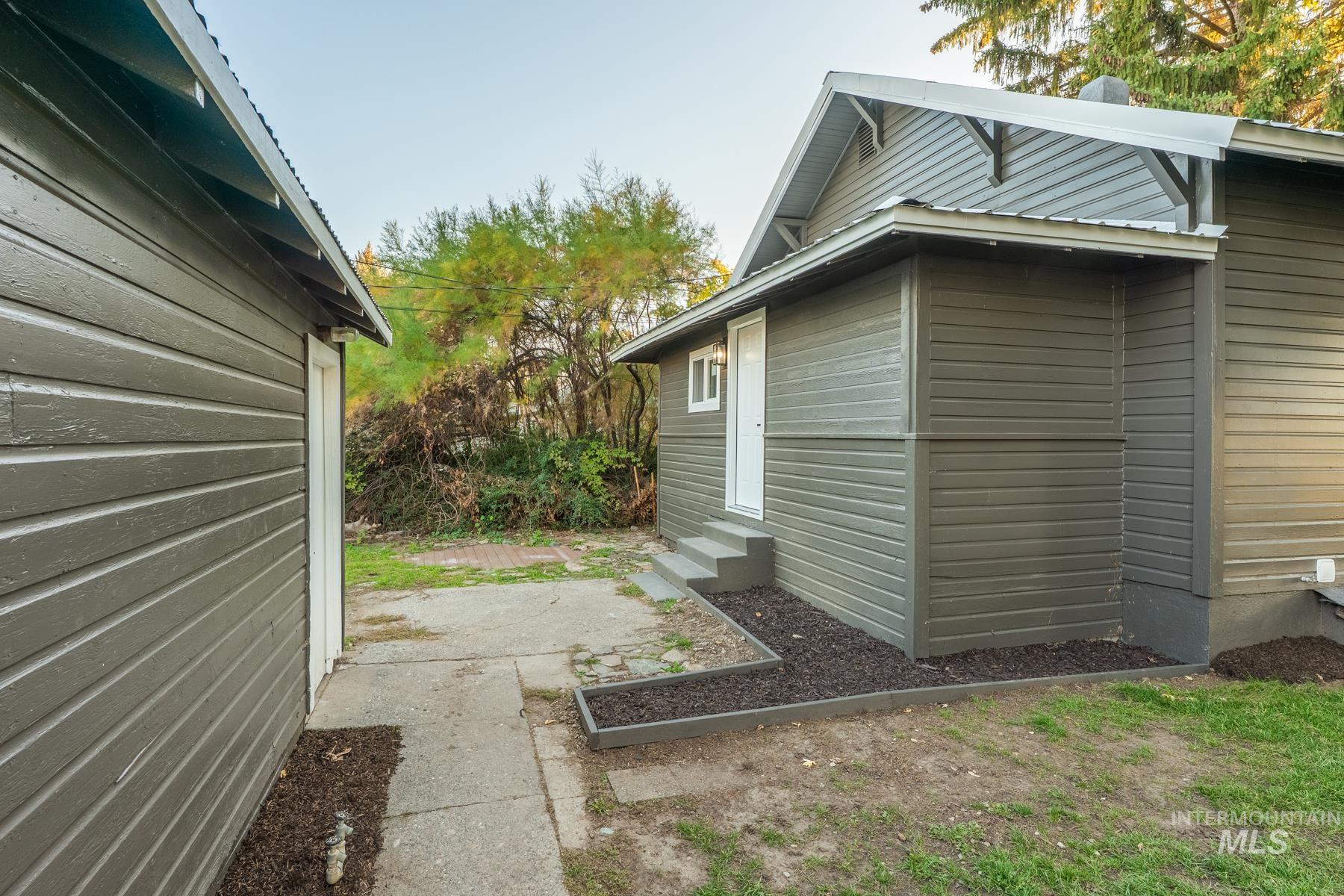 View of side of property with entry steps