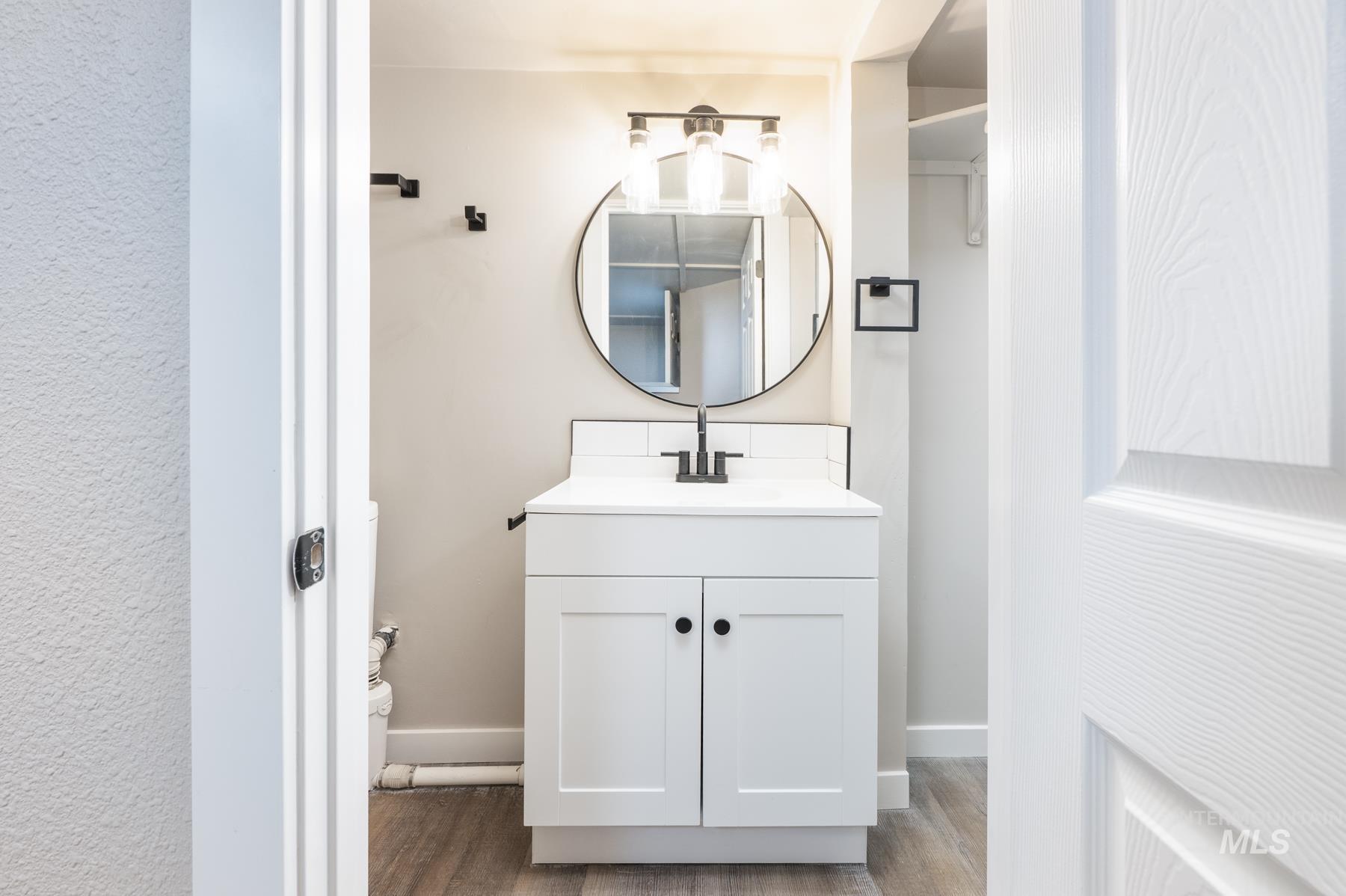 Bathroom featuring vanity and wood finished floors