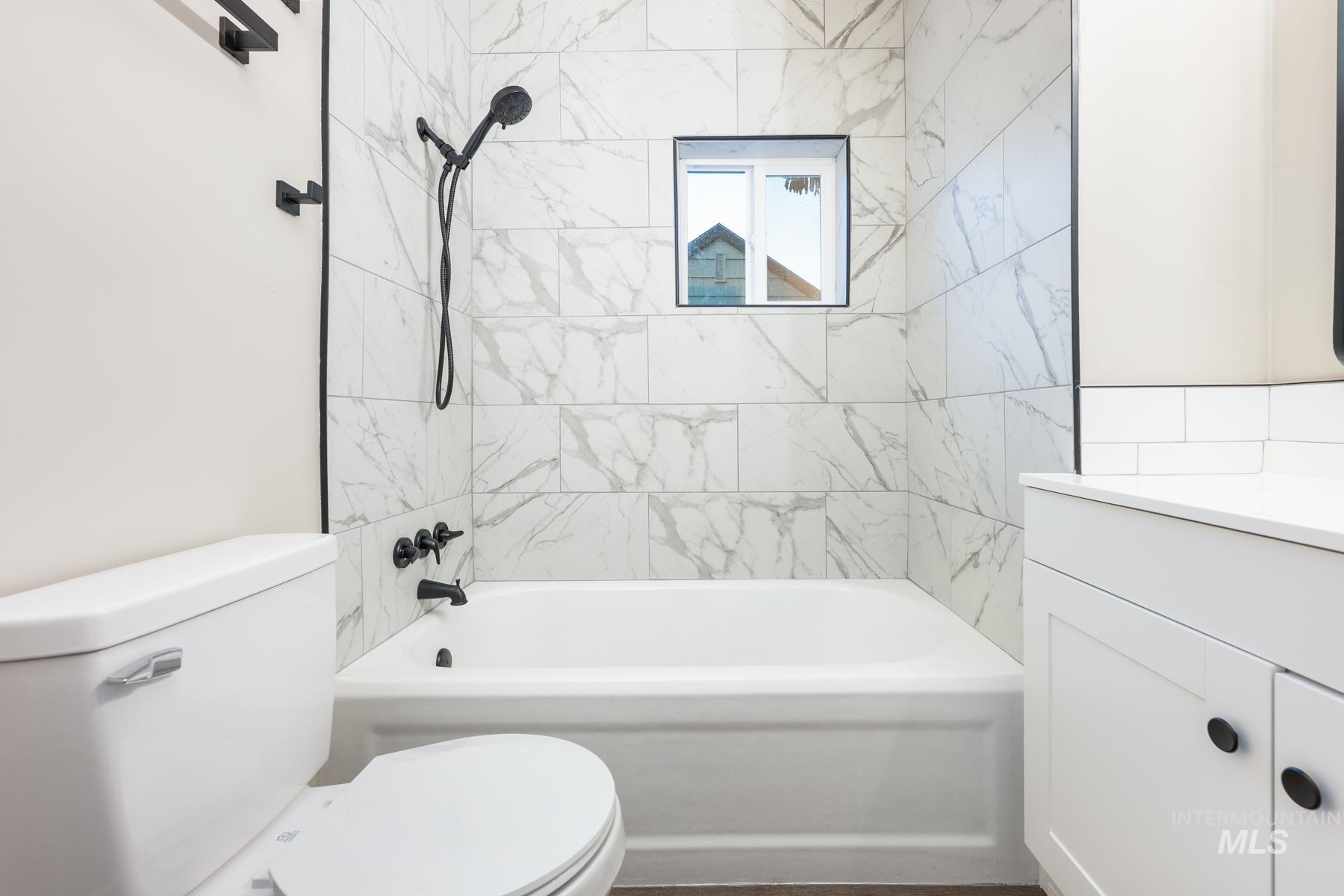 Bathroom featuring vanity and shower / tub combination