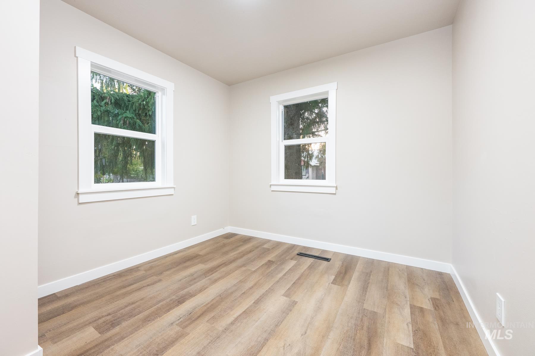 Unfurnished room featuring light wood-style flooring