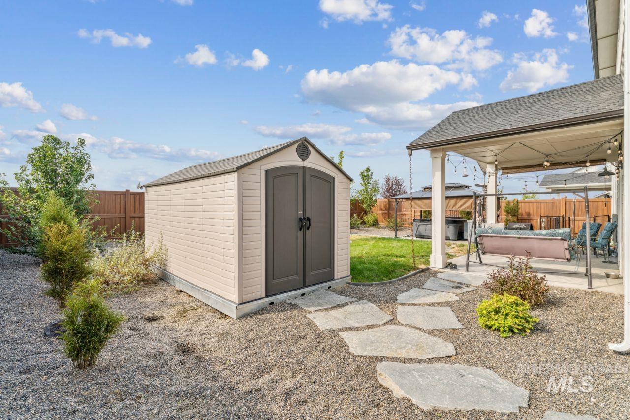 View of shed with a fenced backyard