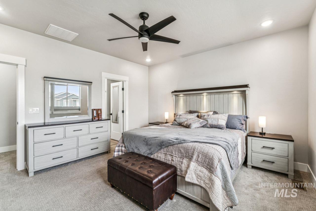 Bedroom featuring light carpet, a ceiling fan, and recessed lighting