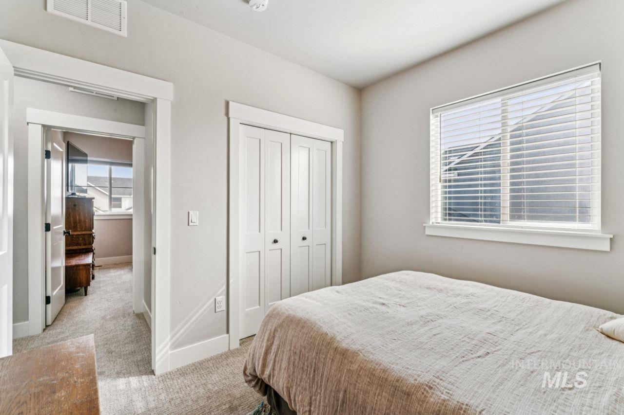 Bedroom featuring light carpet and a closet