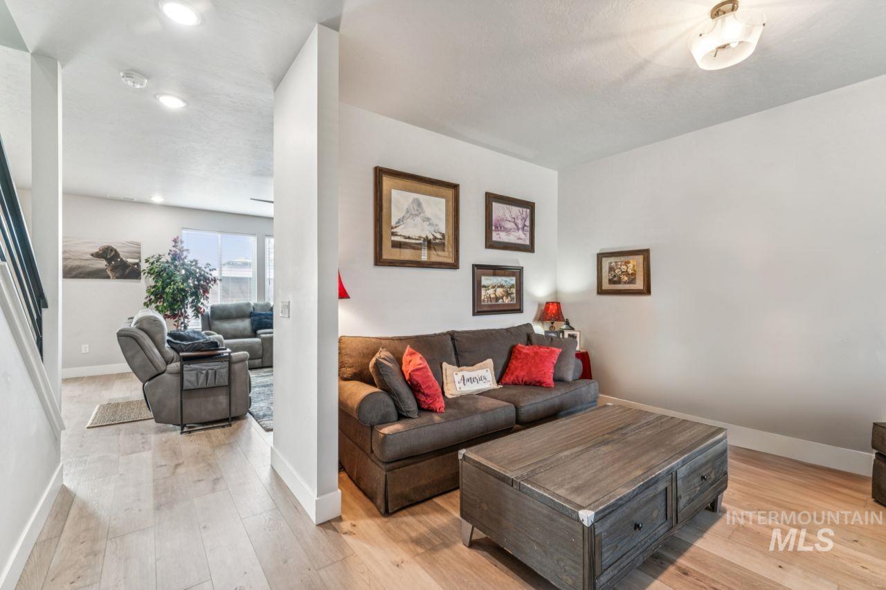 Living area with light wood-style floors and recessed lighting