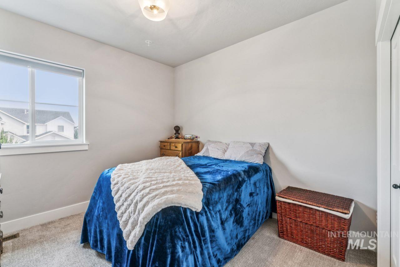 Carpeted bedroom featuring baseboards