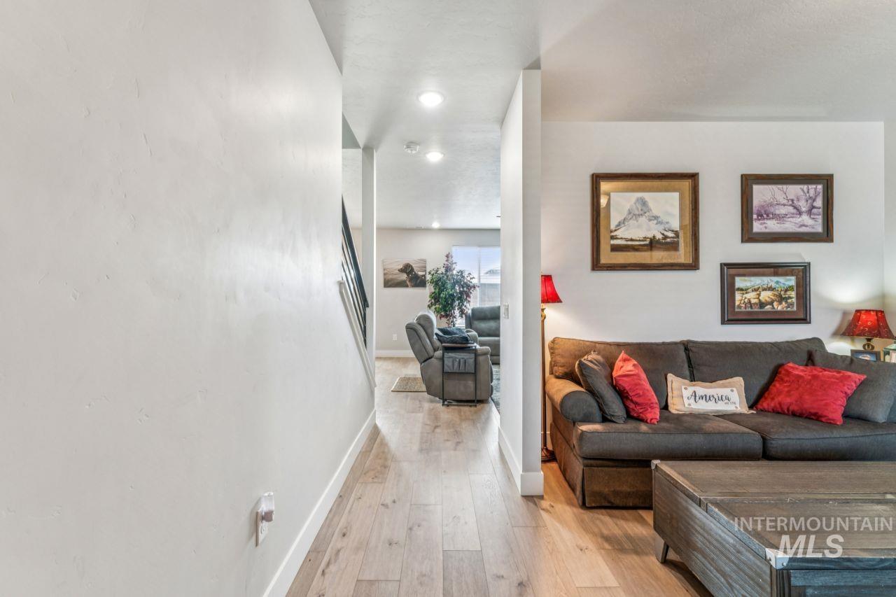 Living room featuring light wood finished floors and recessed lighting