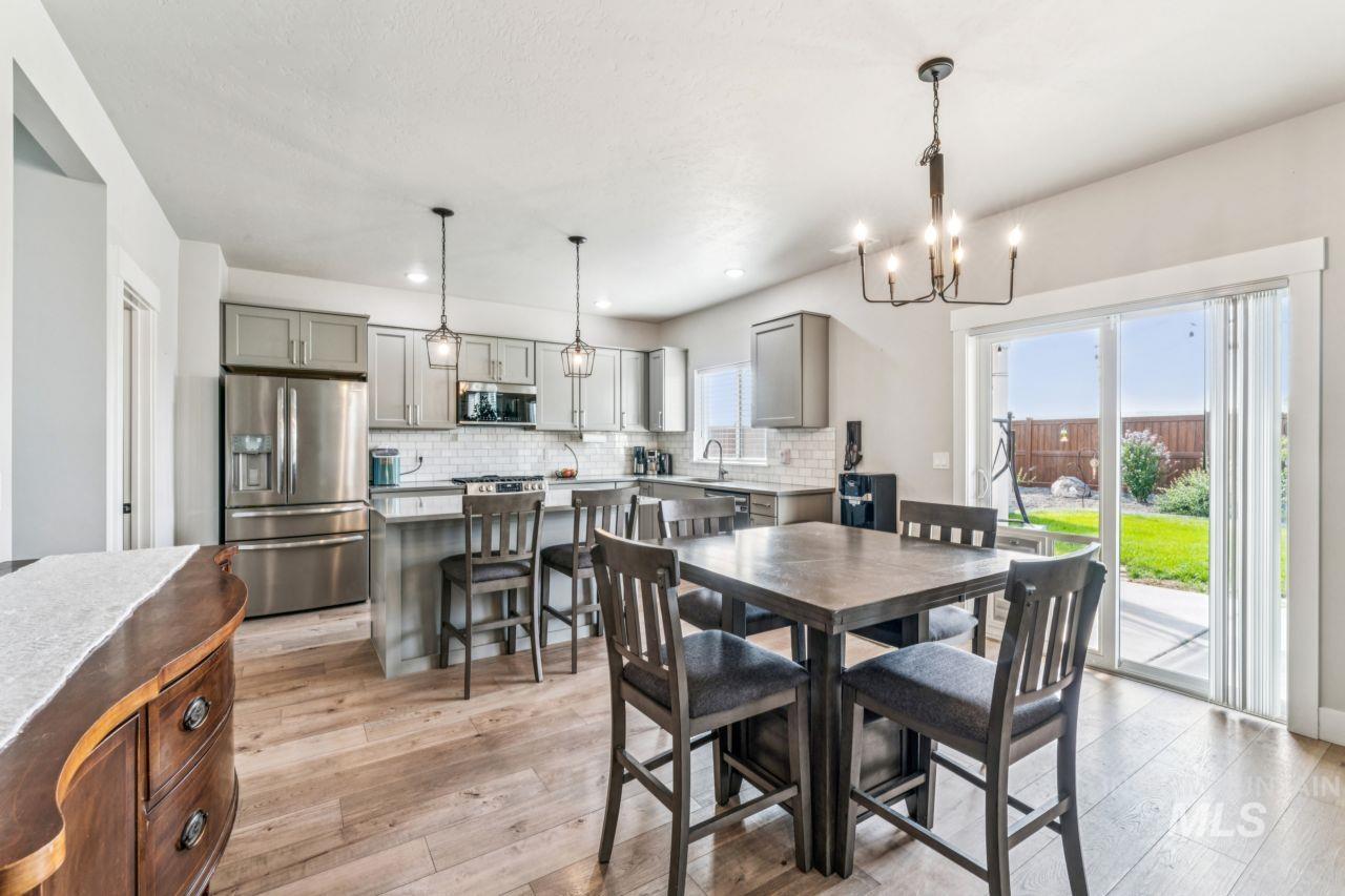 Dining room featuring a chandelier, healthy amount of natural light, light wood-style flooring, and recessed lighting
