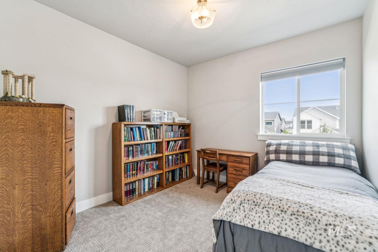 Bedroom with light carpet and baseboards
