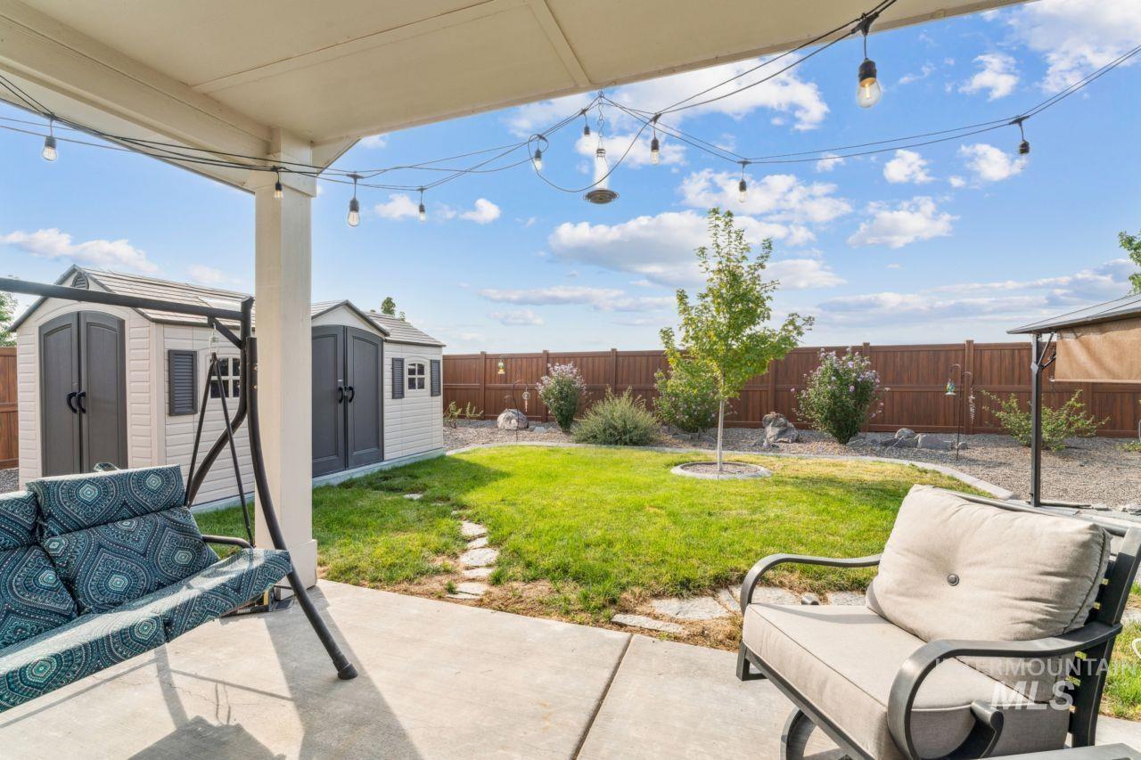 Fenced backyard with a patio area and a storage shed