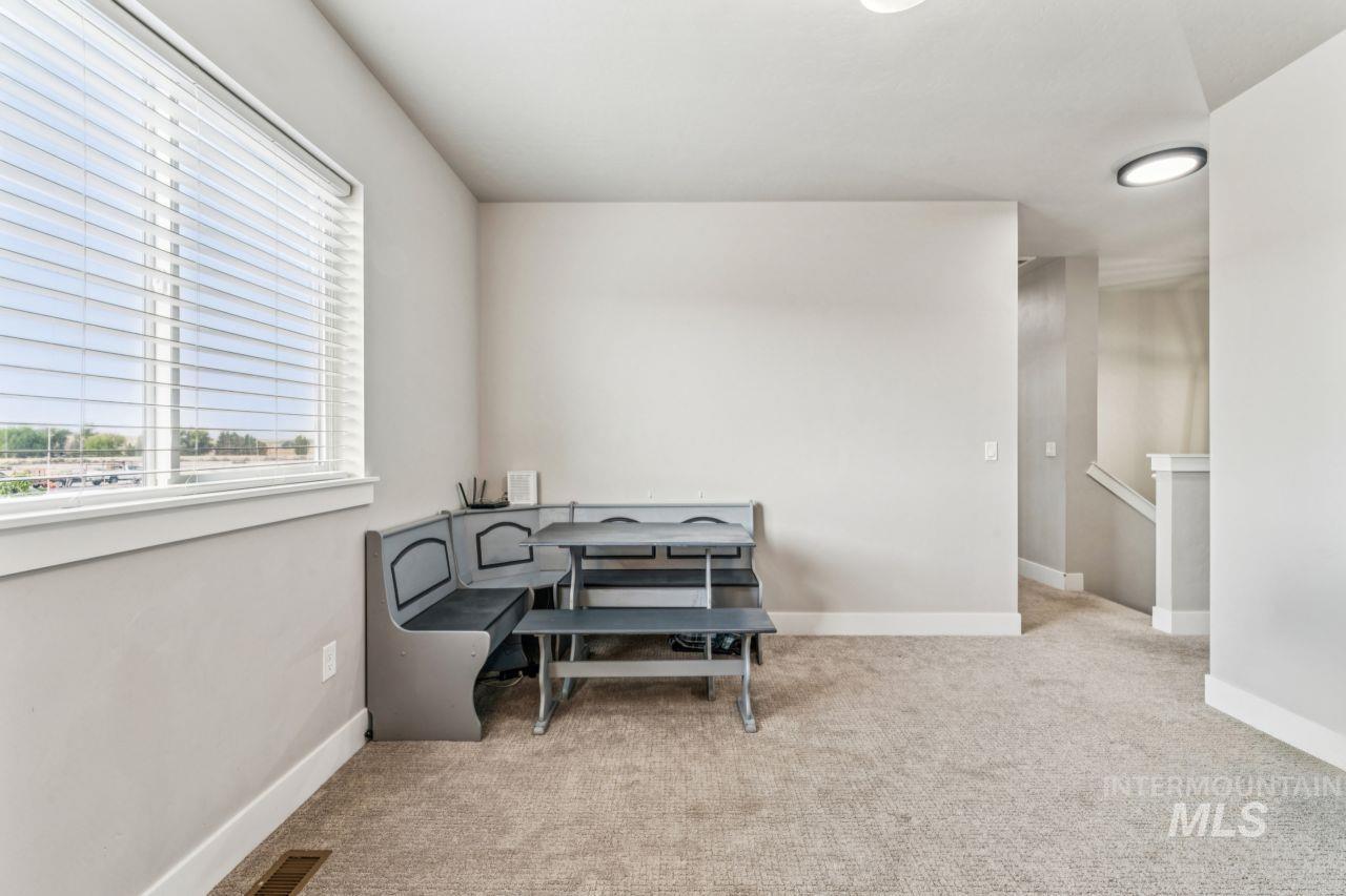 Office with light colored carpet and baseboards