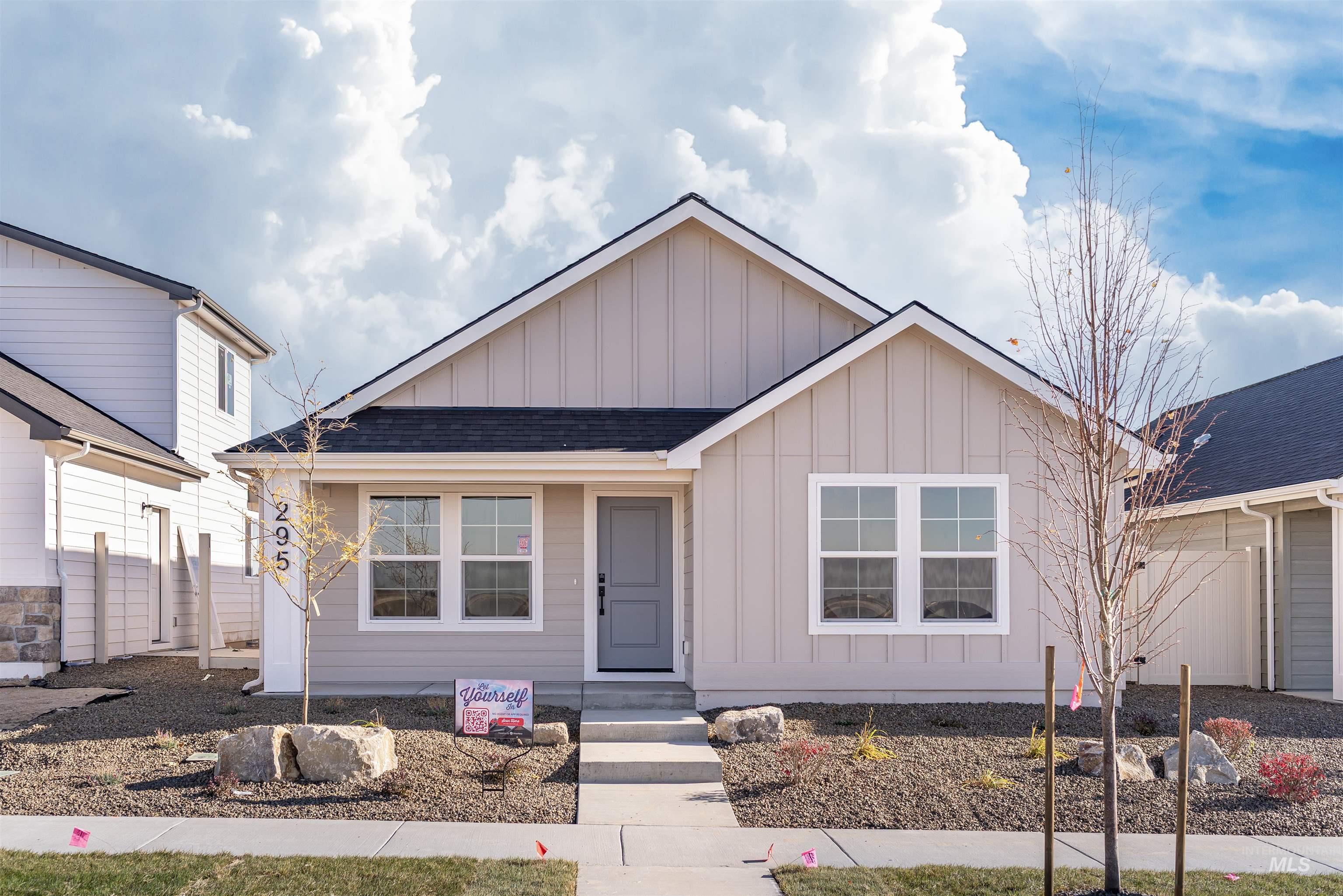 View of front of house featuring board and batten siding and a shingled roof