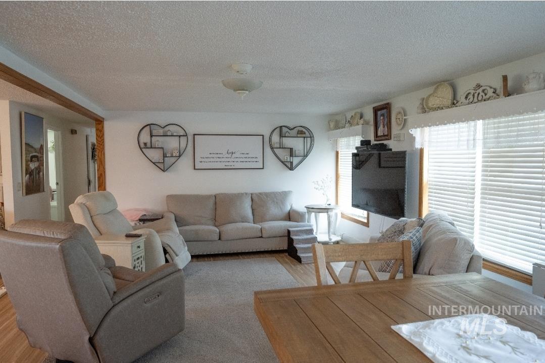 Living area with a textured ceiling and wood finished floors