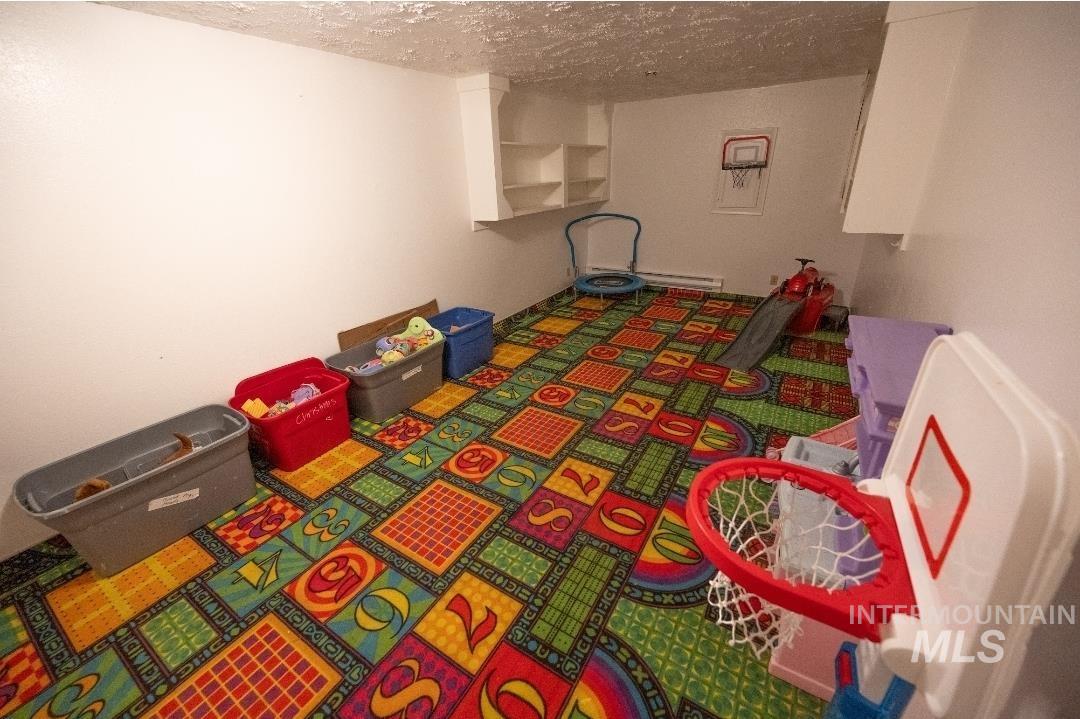 Game room featuring a textured ceiling