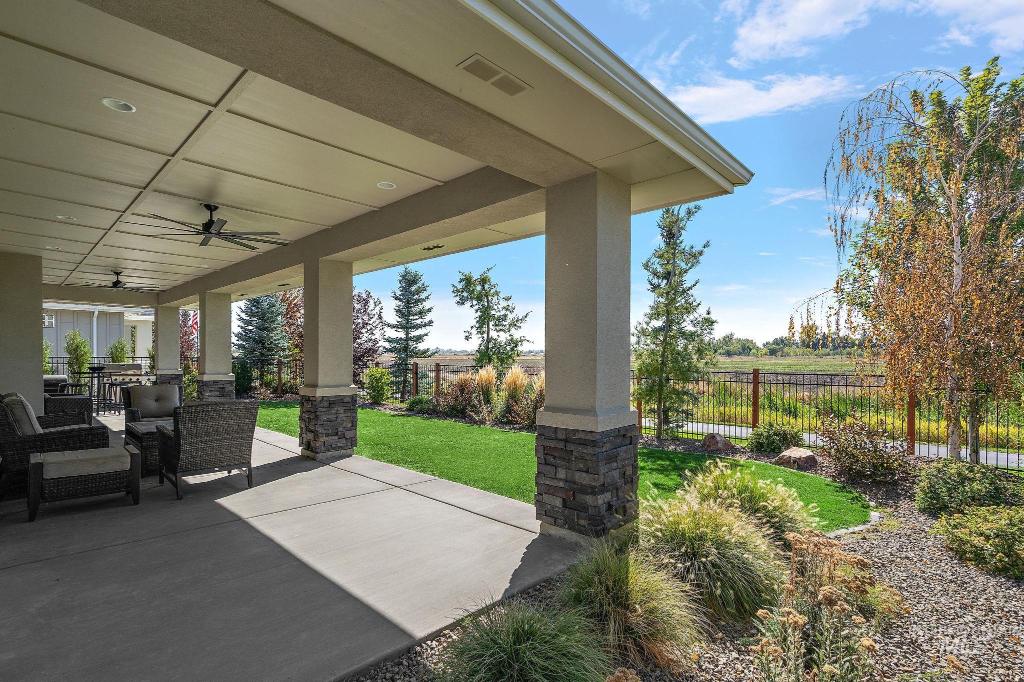 Fenced backyard featuring a patio and a ceiling fan