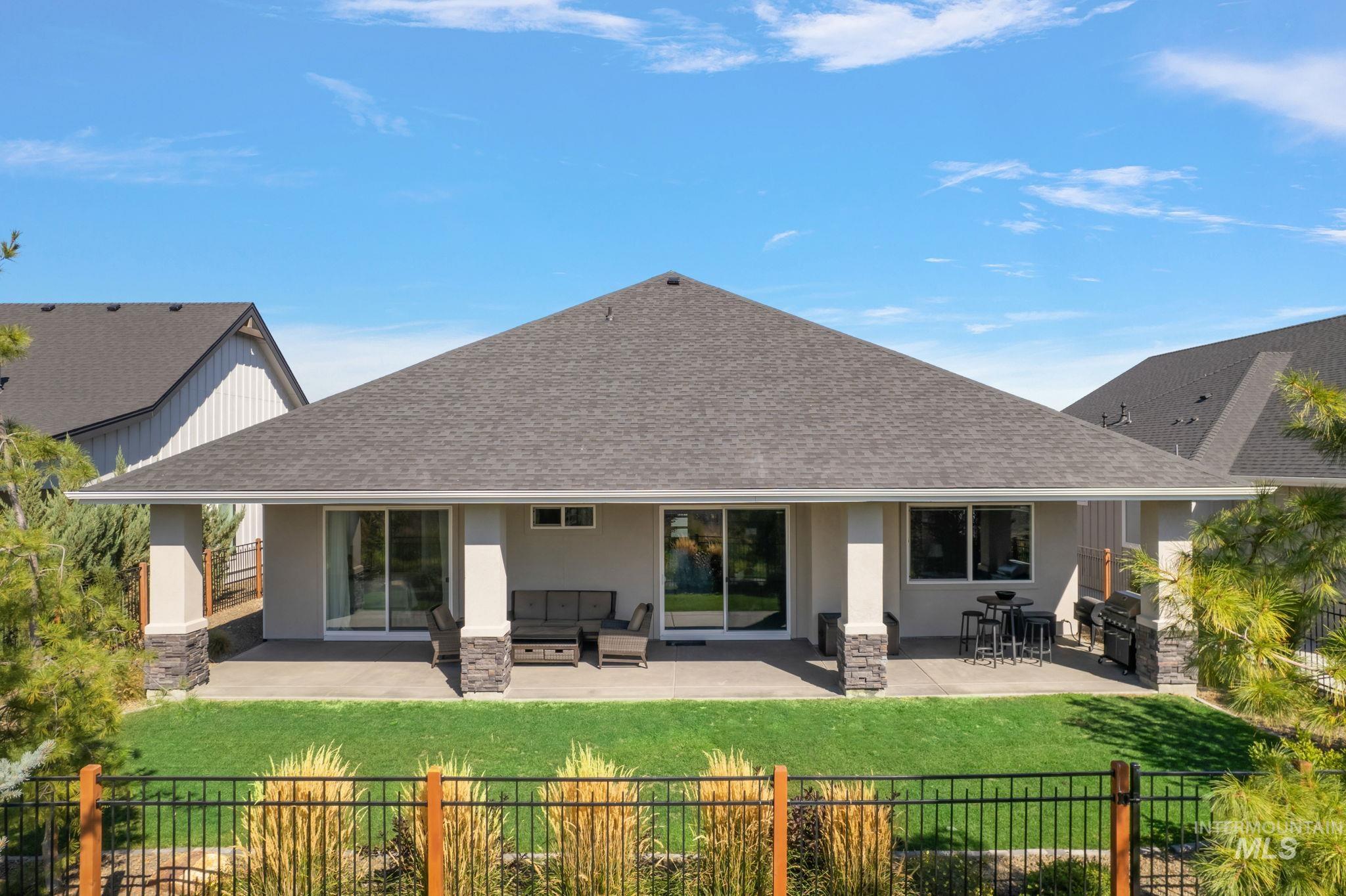 Back of property with a patio area, roof with shingles, stucco siding, and outdoor lounge area