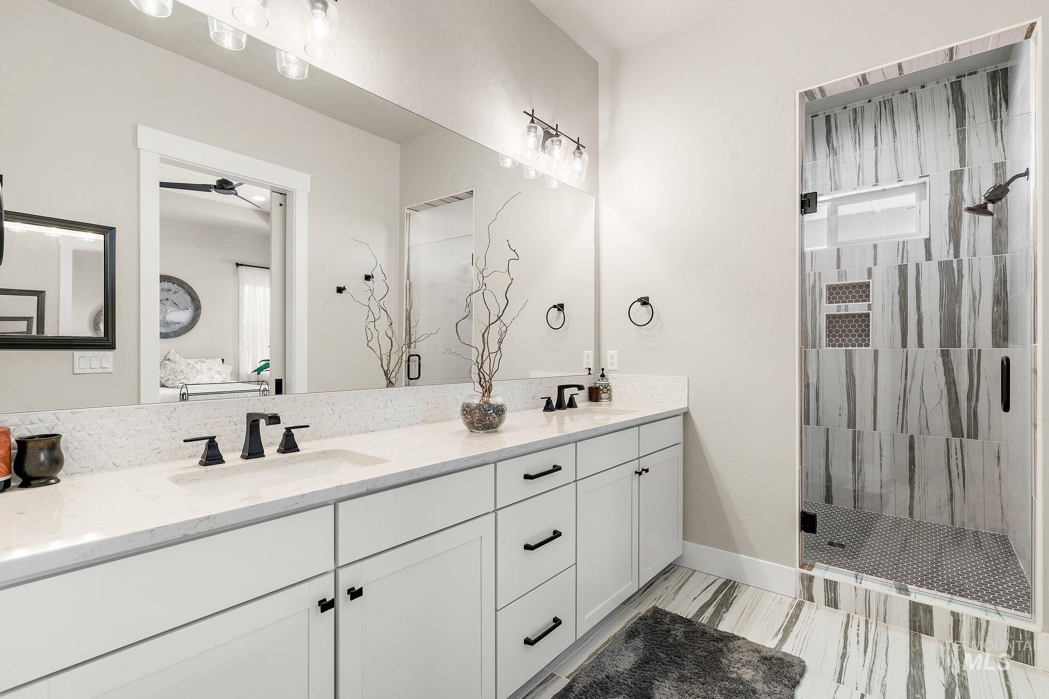 Ensuite bathroom with a shower stall and double vanity