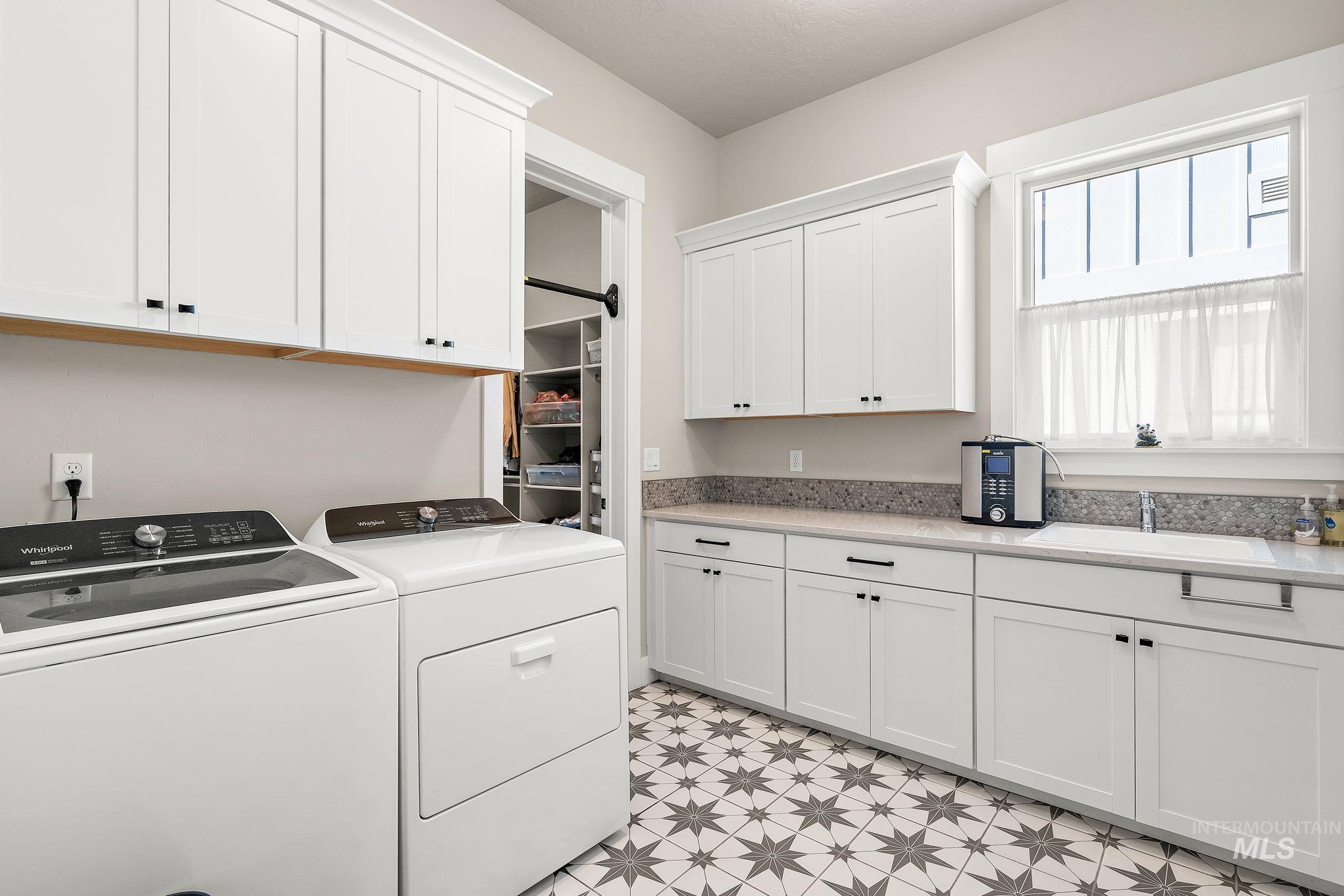 Laundry area featuring cabinet space and separate washer and dryer