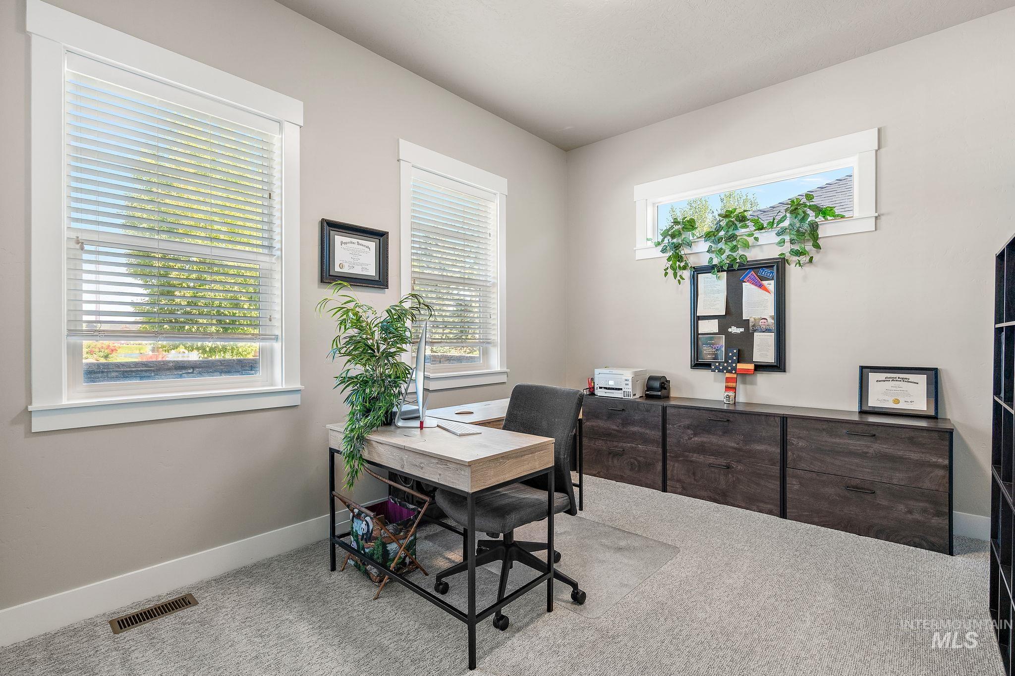 Carpeted office space featuring baseboards