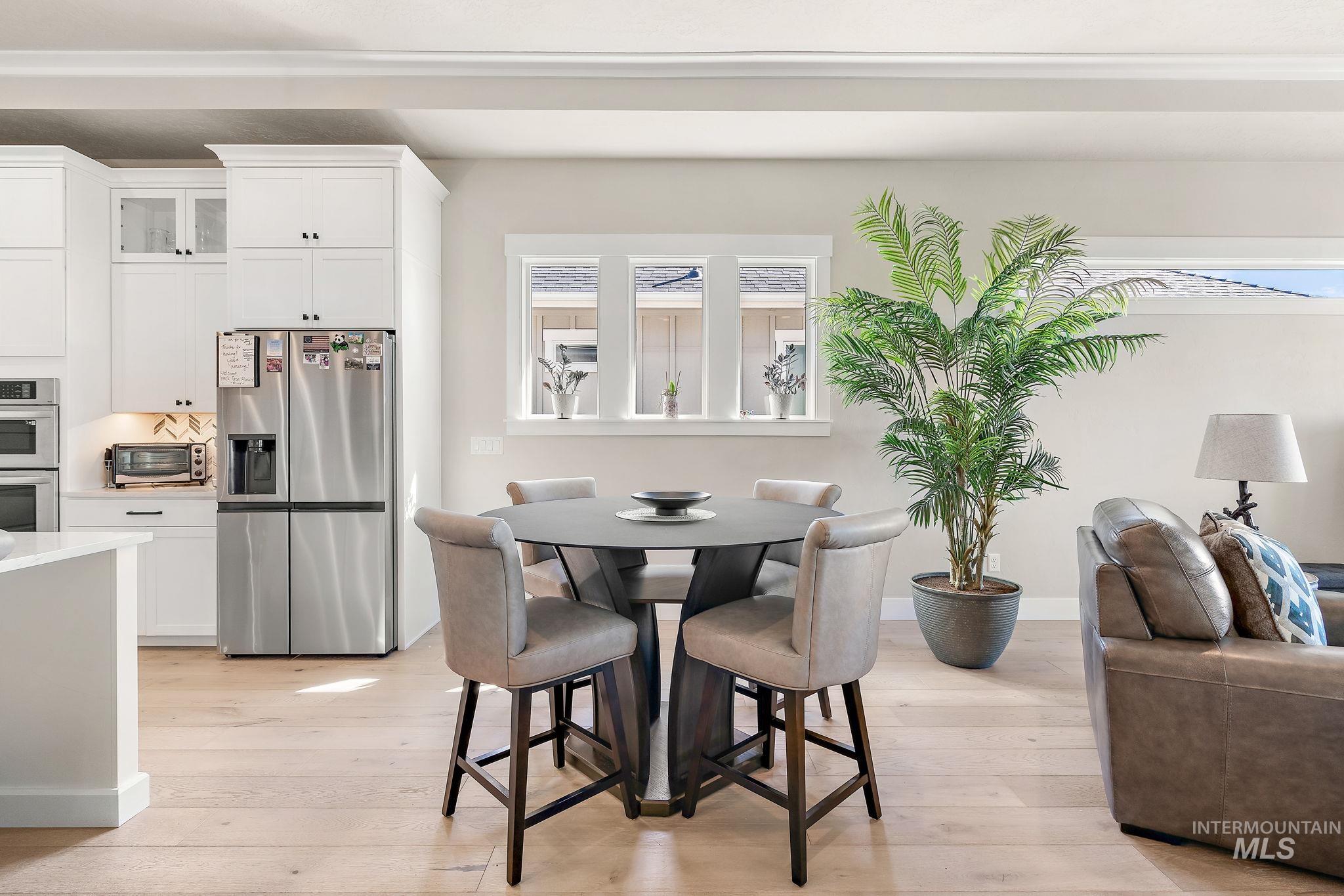 Dining space with light wood finished floors and baseboards
