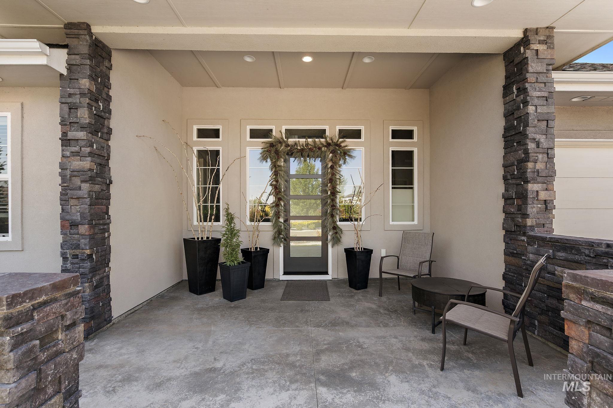 Property entrance with stucco siding and a patio