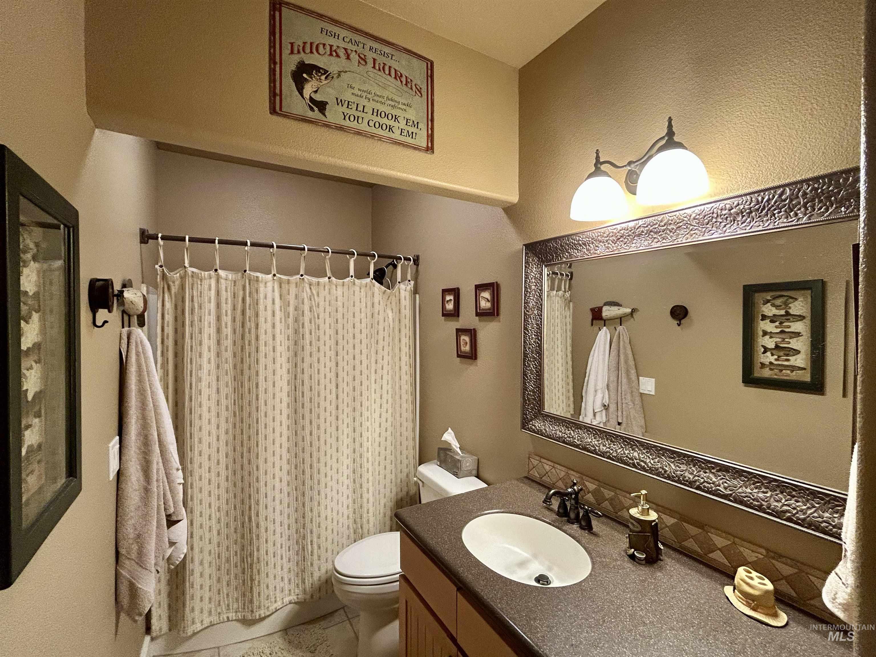 Full bath featuring vanity and curtained shower