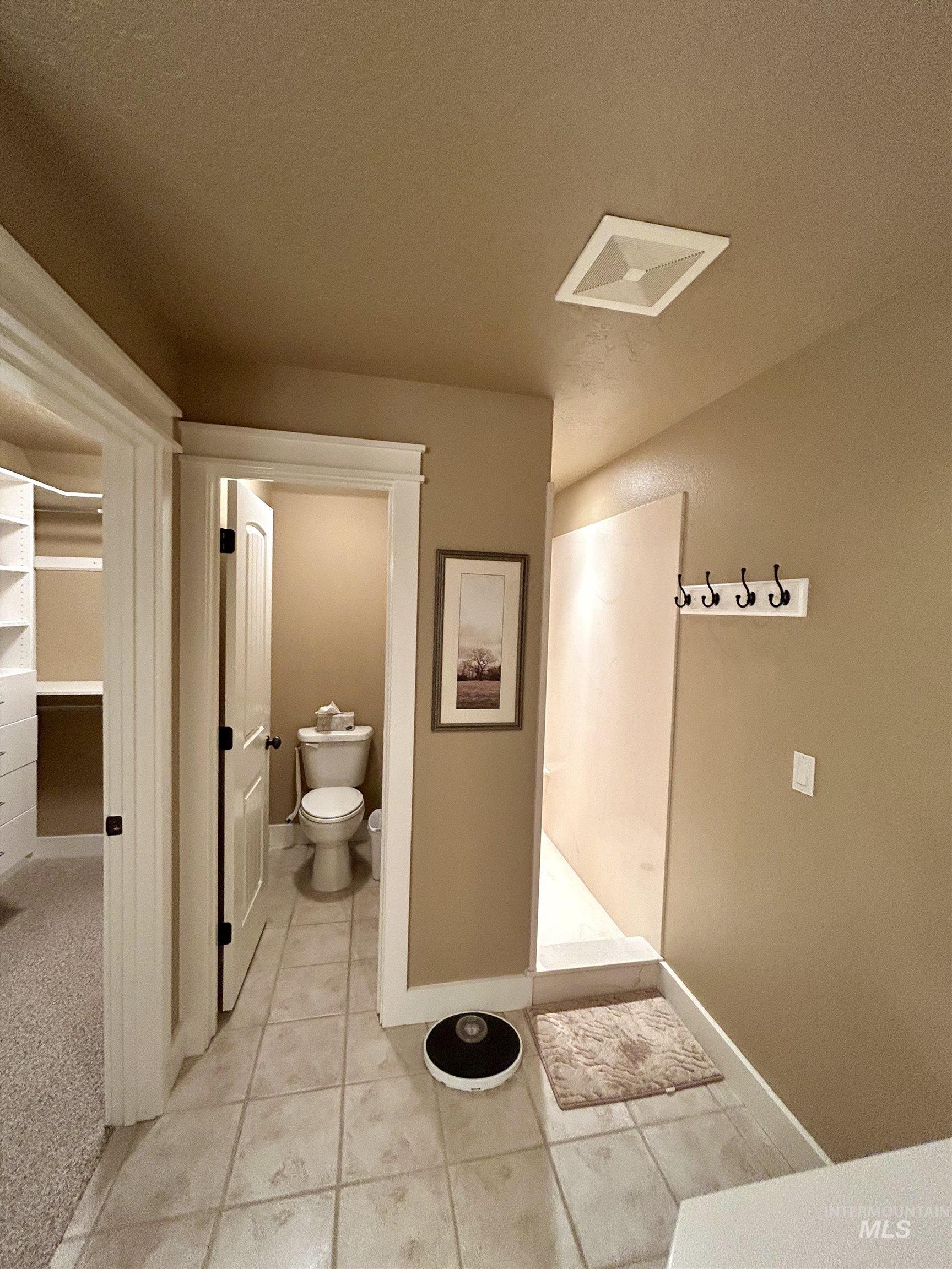 Bathroom featuring a textured ceiling and tile patterned floors