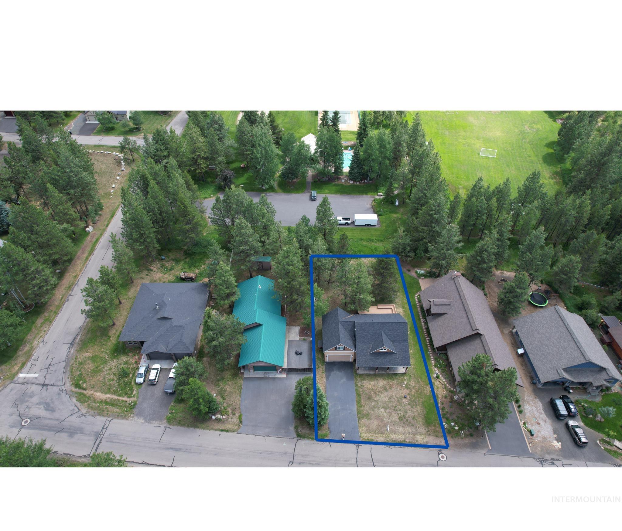 Aerial view of residential area featuring property boundaries highlighted