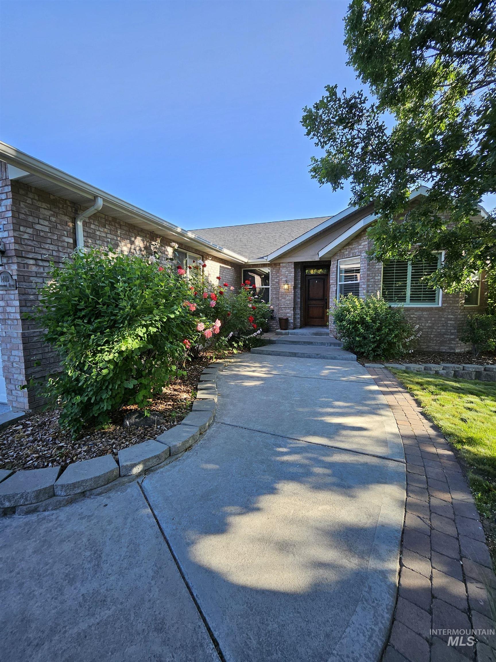 Ranch-style house featuring brick siding