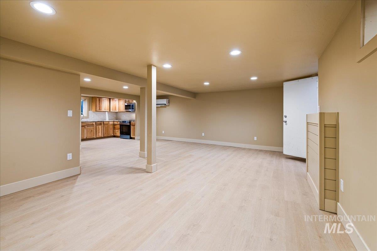 Unfurnished living room featuring light wood-style floors and recessed lighting