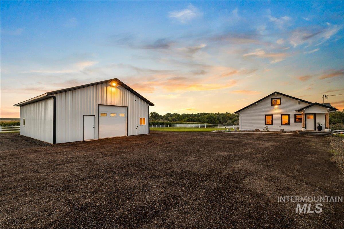 Garage at dusk featuring a garage